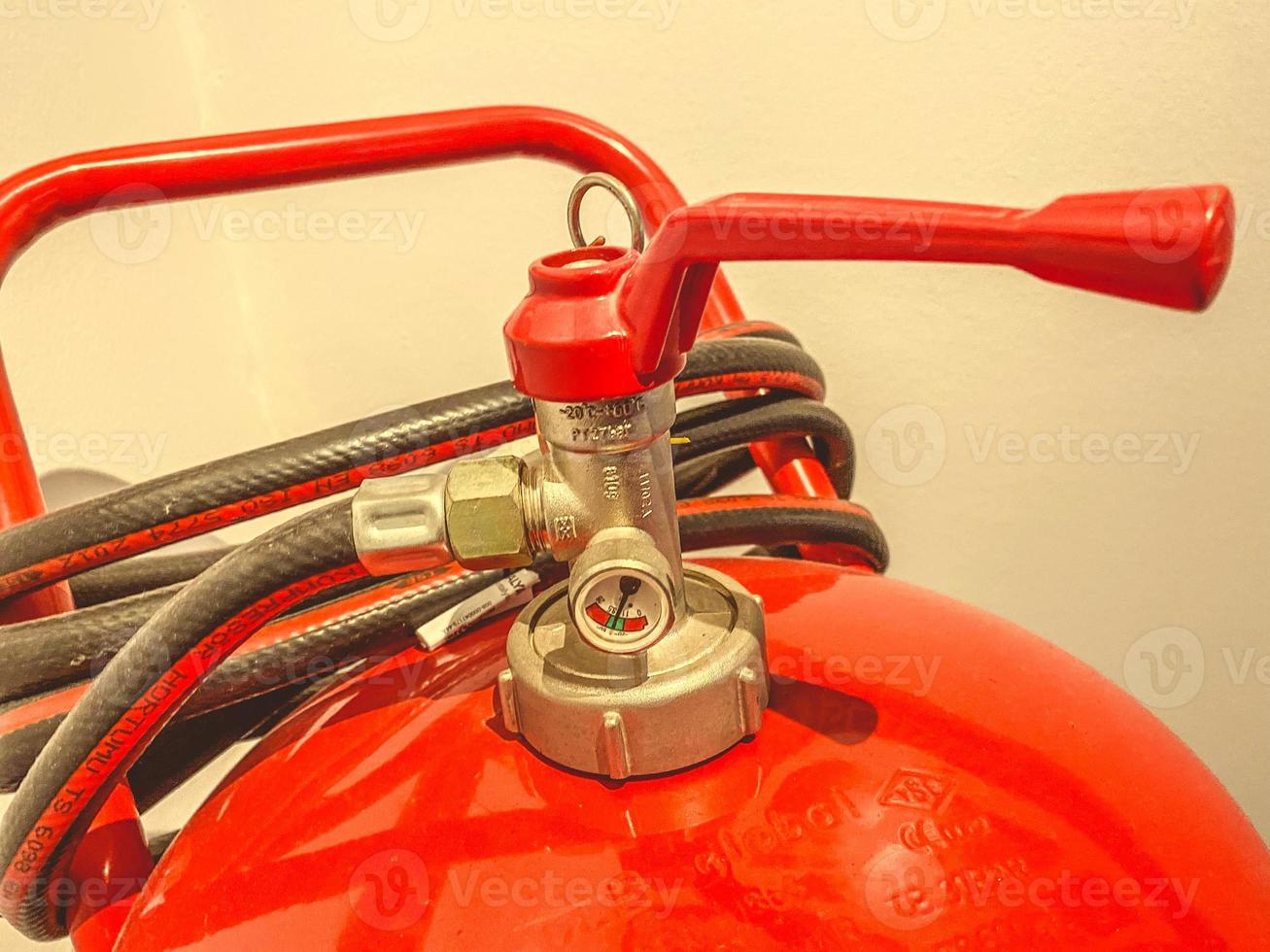 red fire extinguisher. fire extinguishing with white foam. safety during the ignition of combustible materials. working tool for firefighters photo