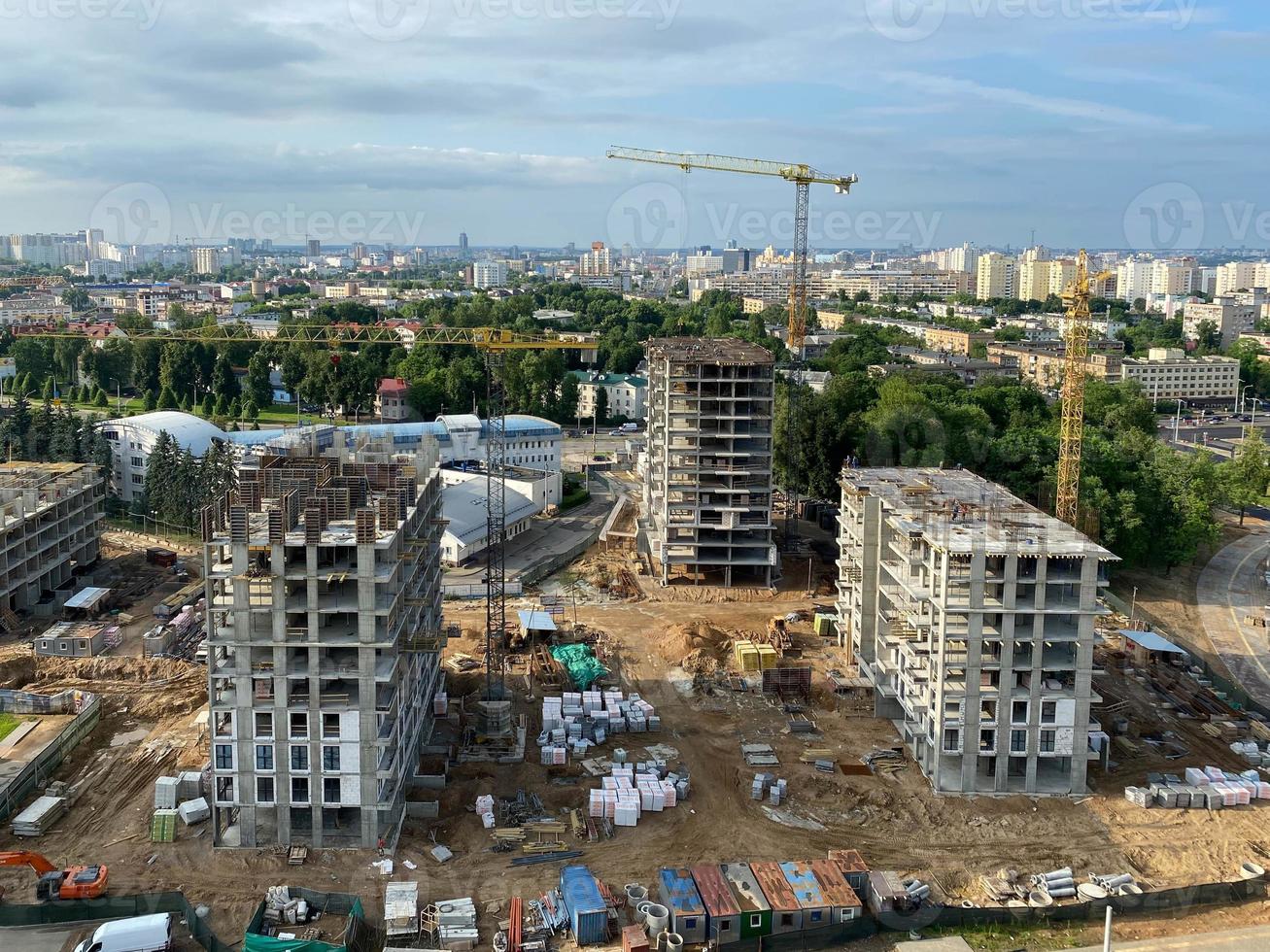 A view from a height of a large modern construction site of tall large houses and multi-storey buildings. A construction site for the development of a new microdistrict in a big city photo