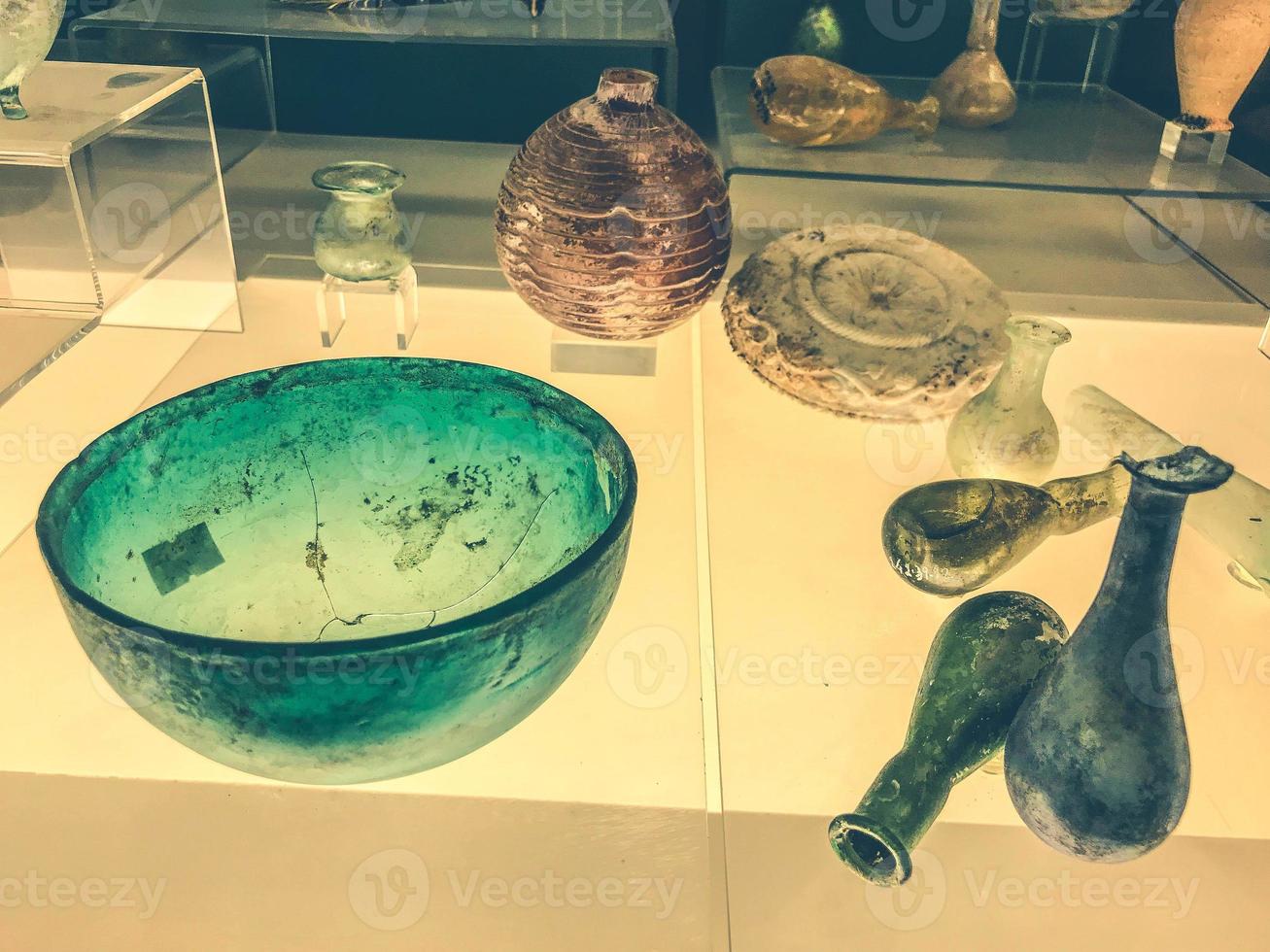 Museum piece. ancient flasks made of glass and transparent materials behind glass. dishes for chemical experiments photo
