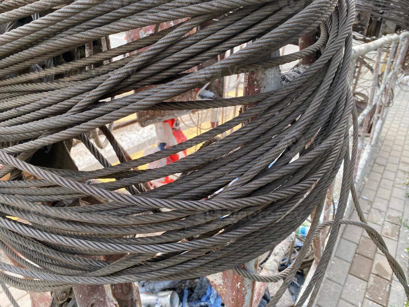 Industrial sturdy heavy duty iron metal braided rope for lifting loads. Construction hi-tech highly reliable equipment photo