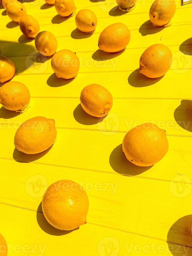 art installation. yellow lemons are attached to the wall. bright fruits made of plastic and artificial materials on a tree. decoration for the photo zone. creative and unusual background