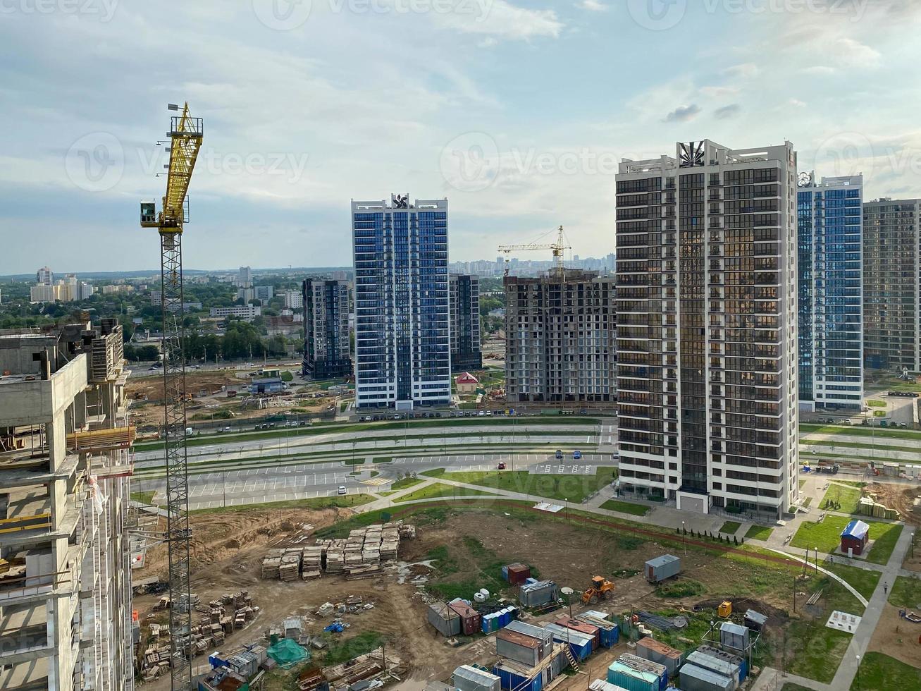 A view from a height of a large modern construction site of tall large houses and multi-storey buildings. A construction site for the development of a new microdistrict in a big city photo