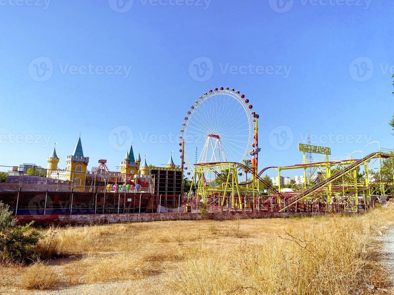 Ferris wheel in the desert on a background of sand. wheel with many cabins for tourists. ride on the carousel, an interesting sightseeing tour in the attraction photo