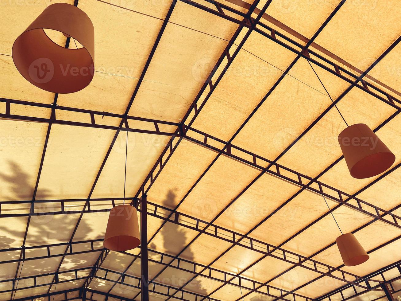 rest in an expensive hotel. near the beach dining under the open sky. orange lamps on the ceiling, a cozy place to have a snack and chat with friends photo