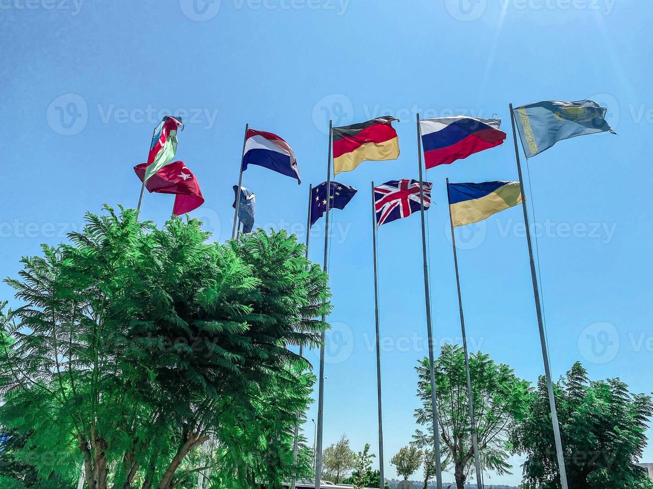 central square in the city. on it are flagpoles with flags of different countries. international cooperation, friendship of peoples photo