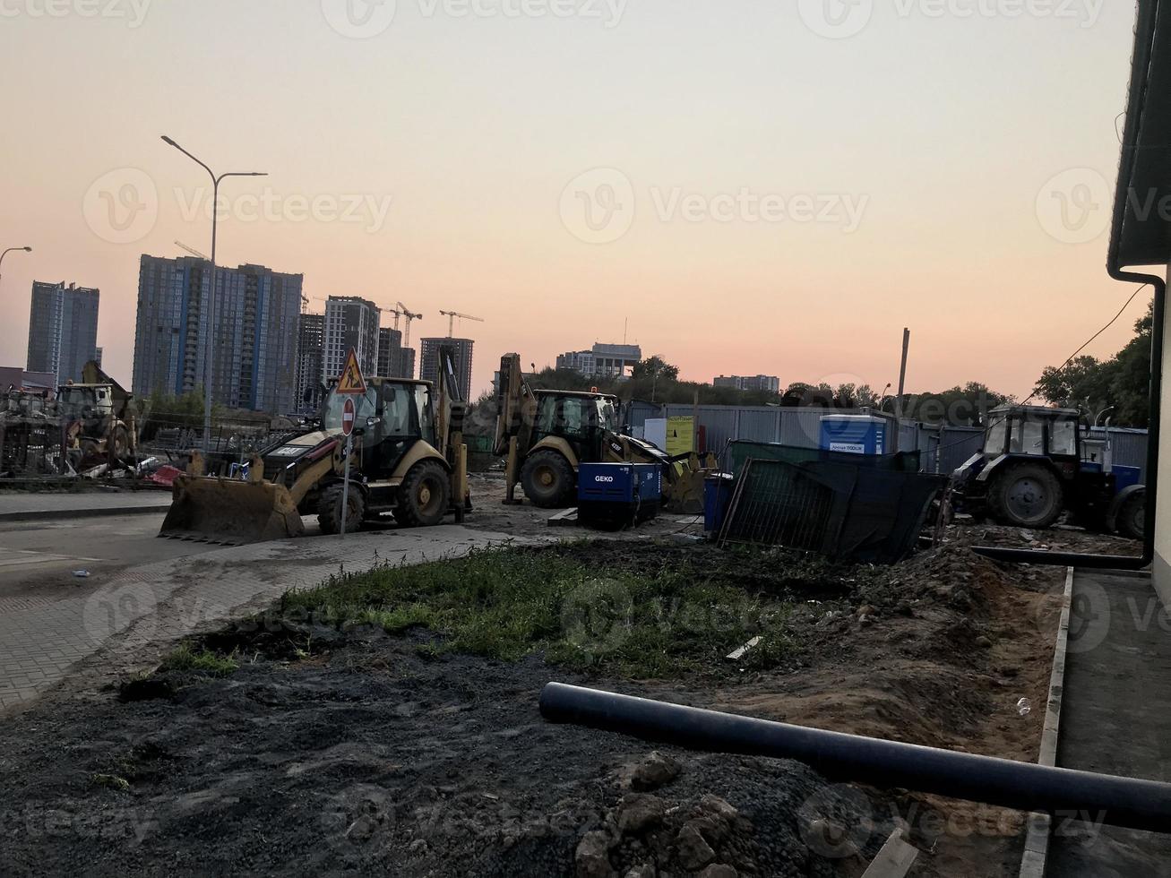 asphalt paving machine. construction equipment. construction of a new microdistrict. asphalt and concrete roads are being laid in the new microdistrict photo
