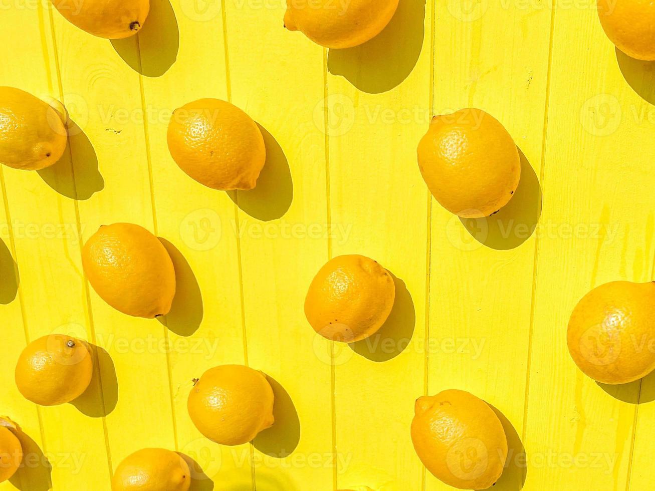 Slices of lemons and oranges on a wooden board. Close-up image of fruit photo