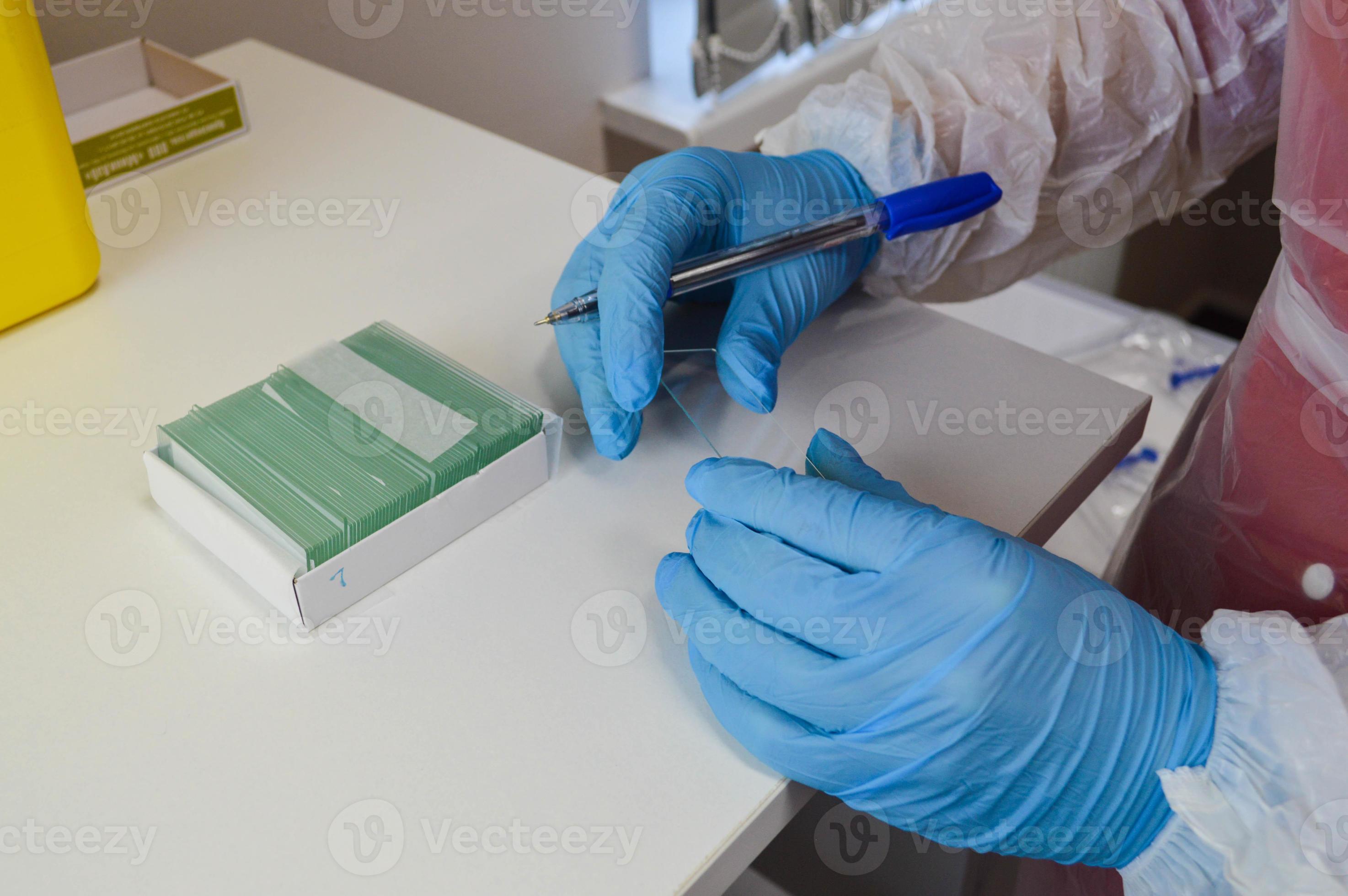 nurse works with biological material. disposable glasses for material