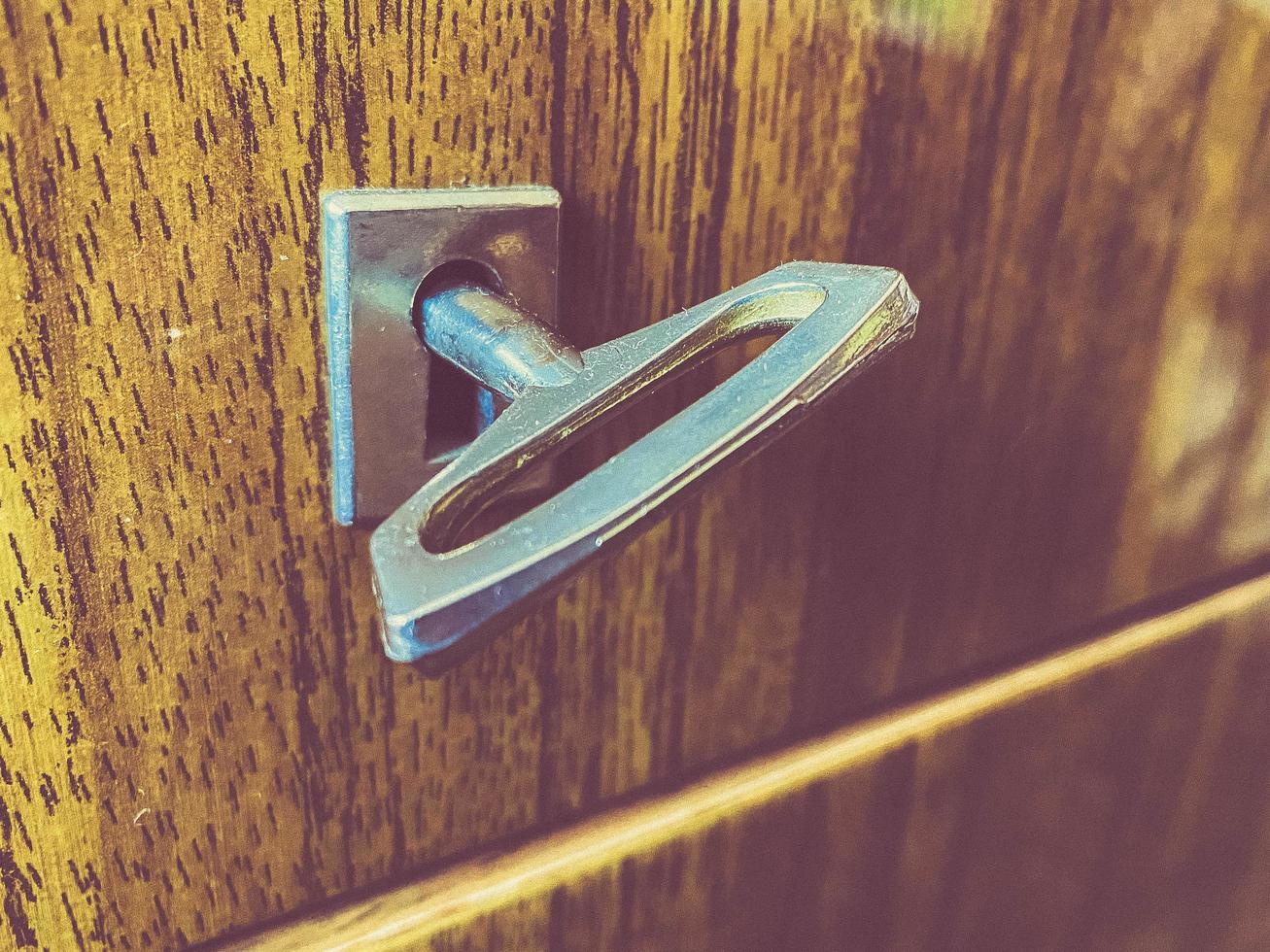 lock on the door in the old house. latch from other people's entry. homemade deadbolt on the door, a well with a key in the closet photo