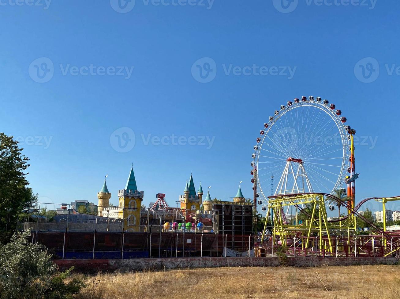 Giant ferris wheel in Amusement park with blue sky background photo