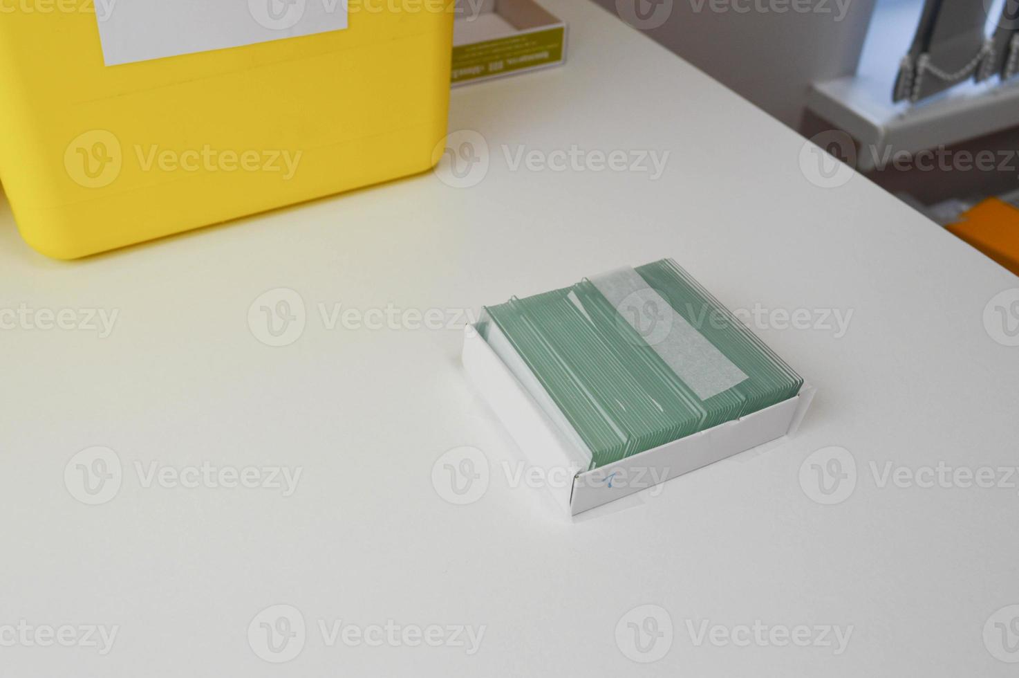 Closeup of hands checking Blood testing glass slide from the archive or old records at laboratory photo