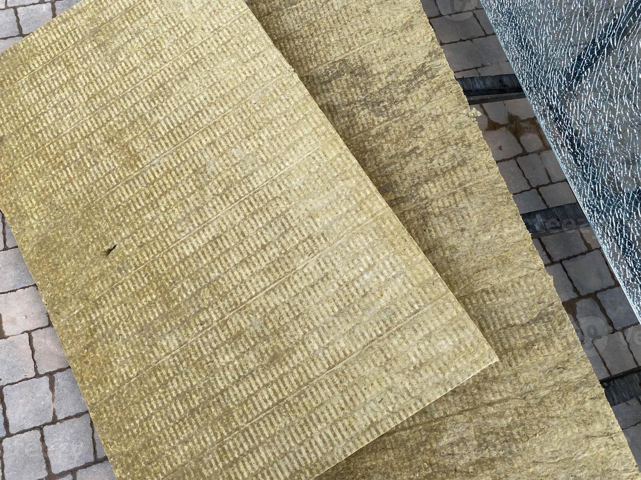 A piece of yellow building industrial insulation for house facades. Mineral wool, building material for building insulation photo