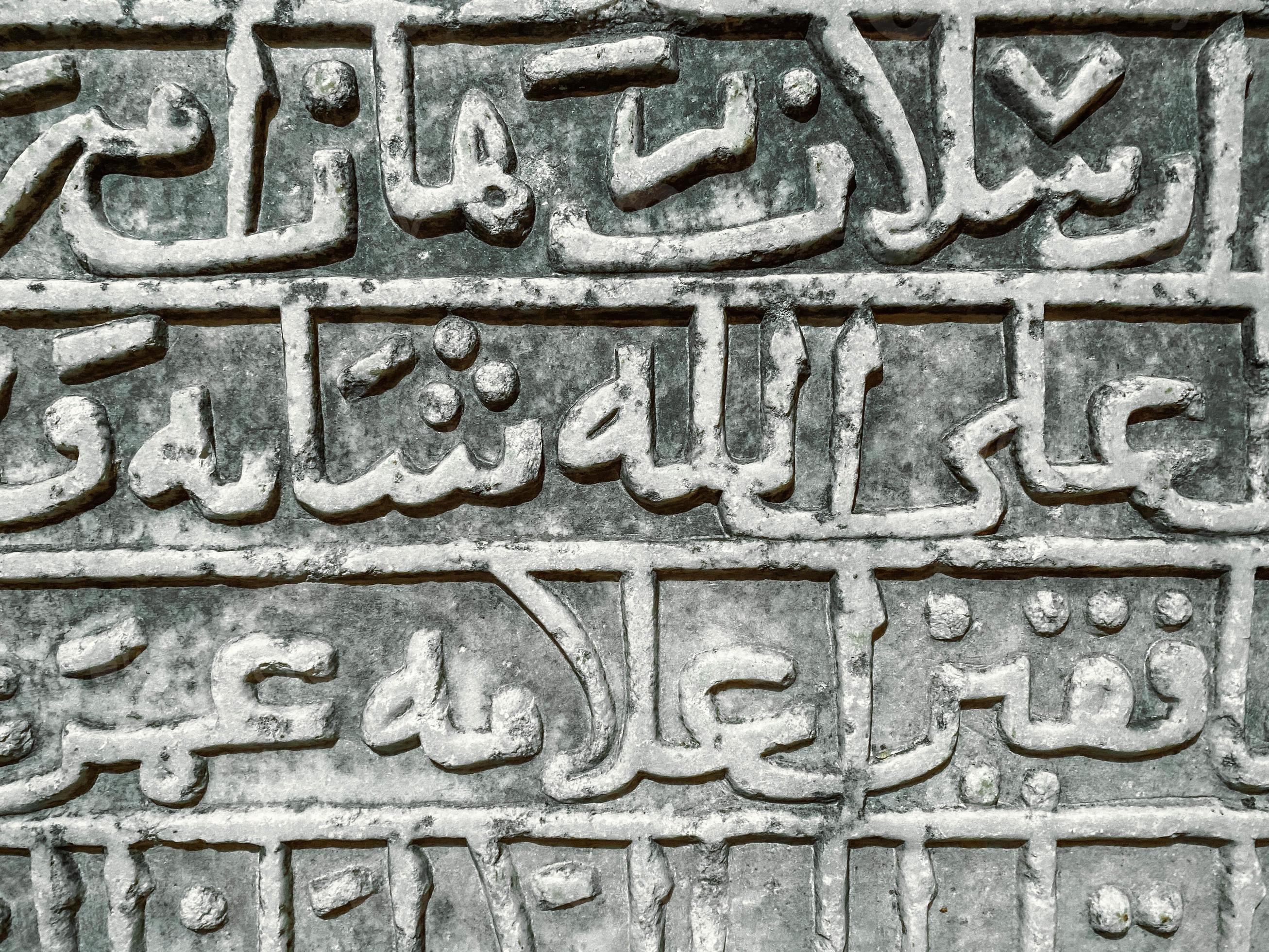 stone texture. letters are carved on a heavy, sandy board. ancient font,  large, tall words are carved with a thick and twisted line, the ancient  creativity of the tribes on a gray