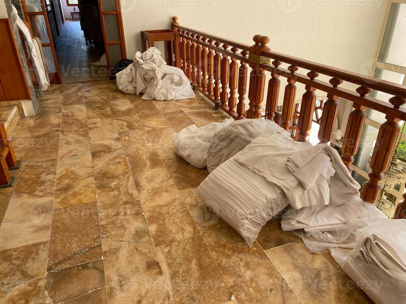 Room cleaning service in the hotel concept. The service room staff laid out bed linen in the hotel corridor for replacement and washing photo