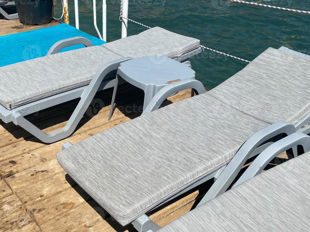 Comfortable sun loungers near the sea photo