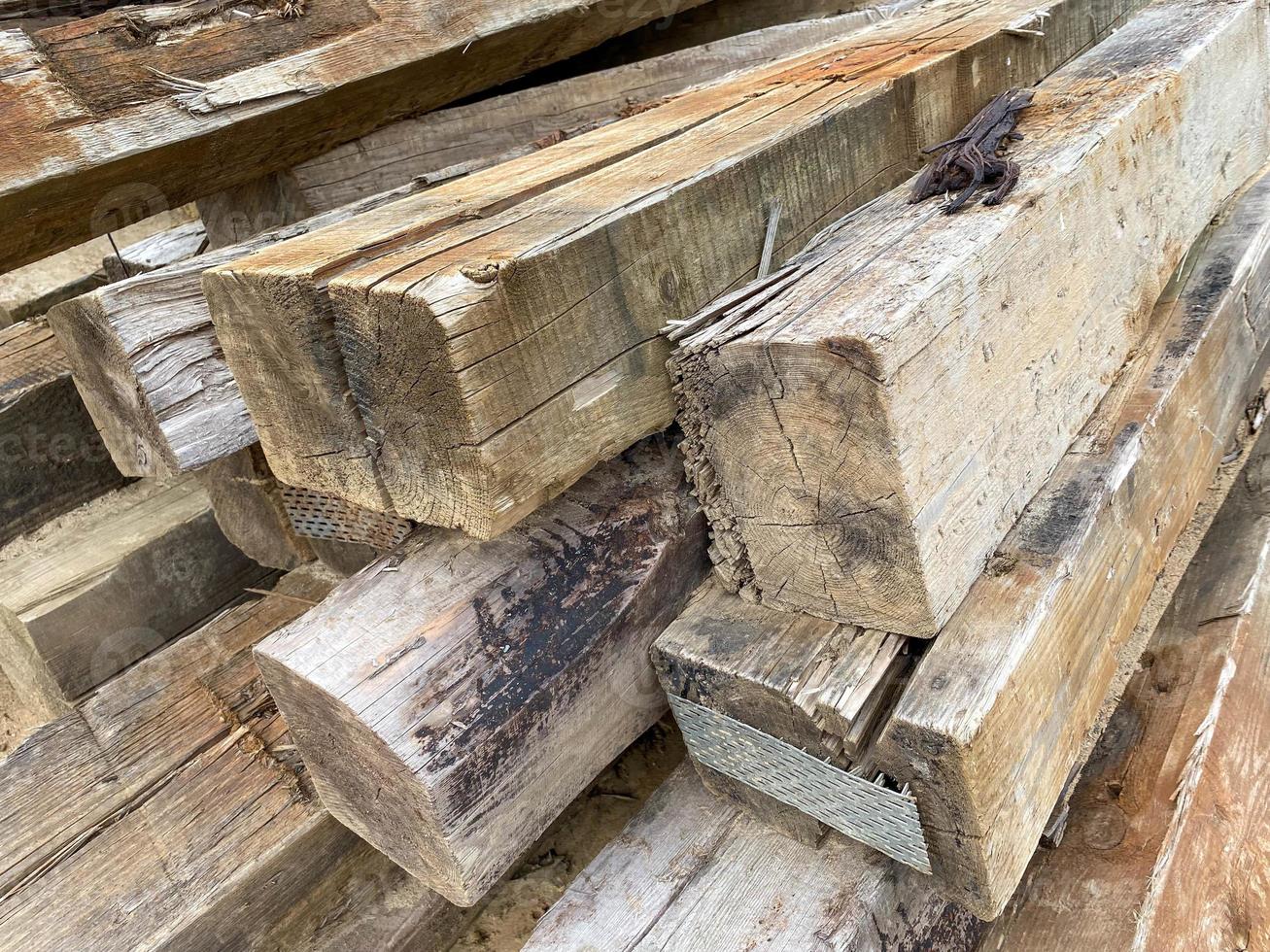Large wooden rectangular logs or large diameter square cross ties at a construction site photo