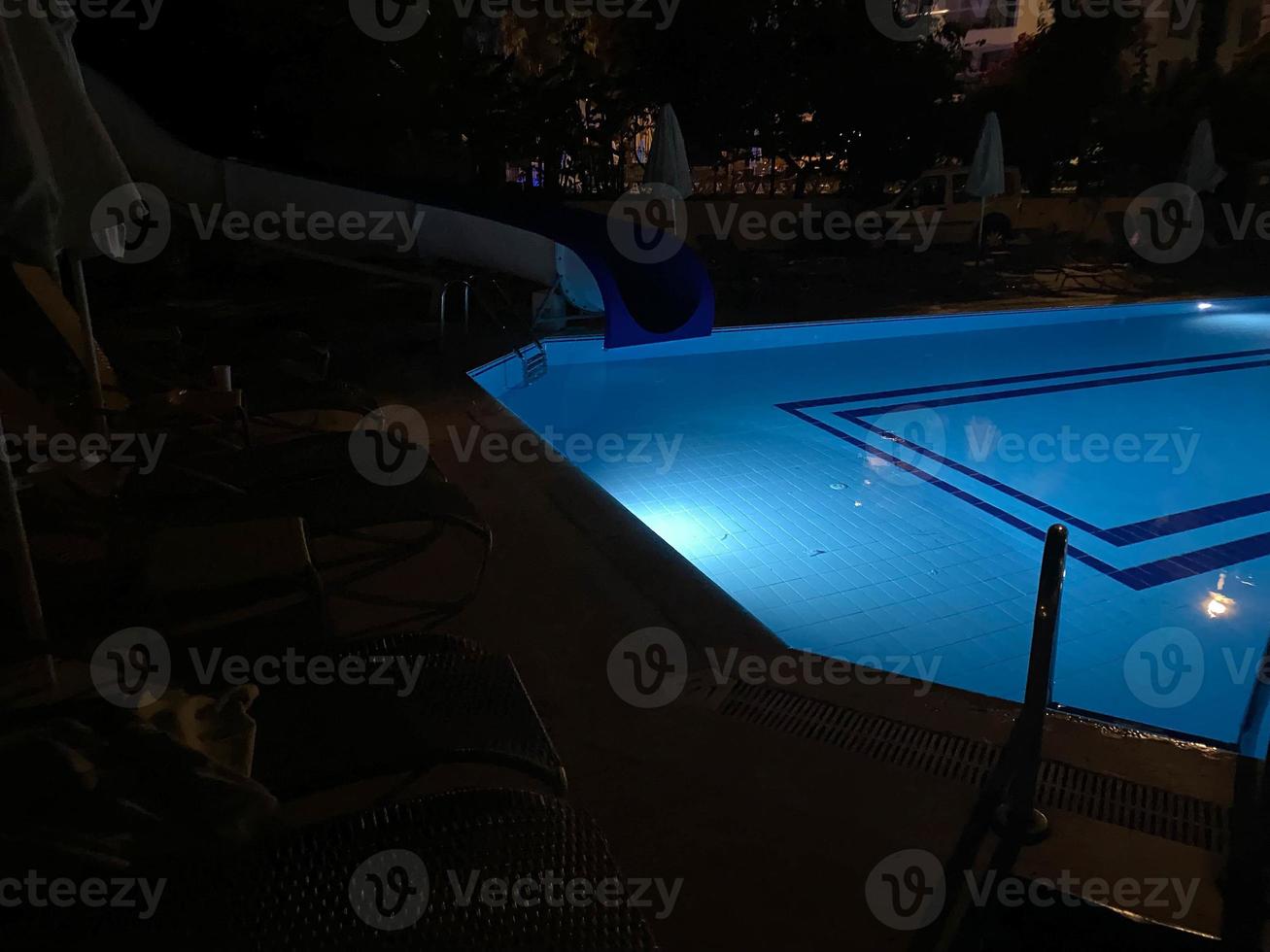 Pool and waterfall at night photo