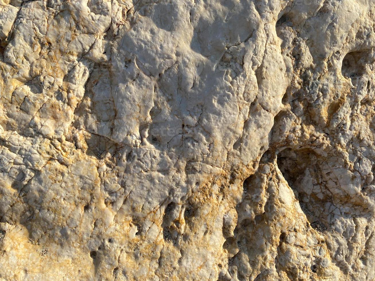 Sandy soil texture, light yellow background photo