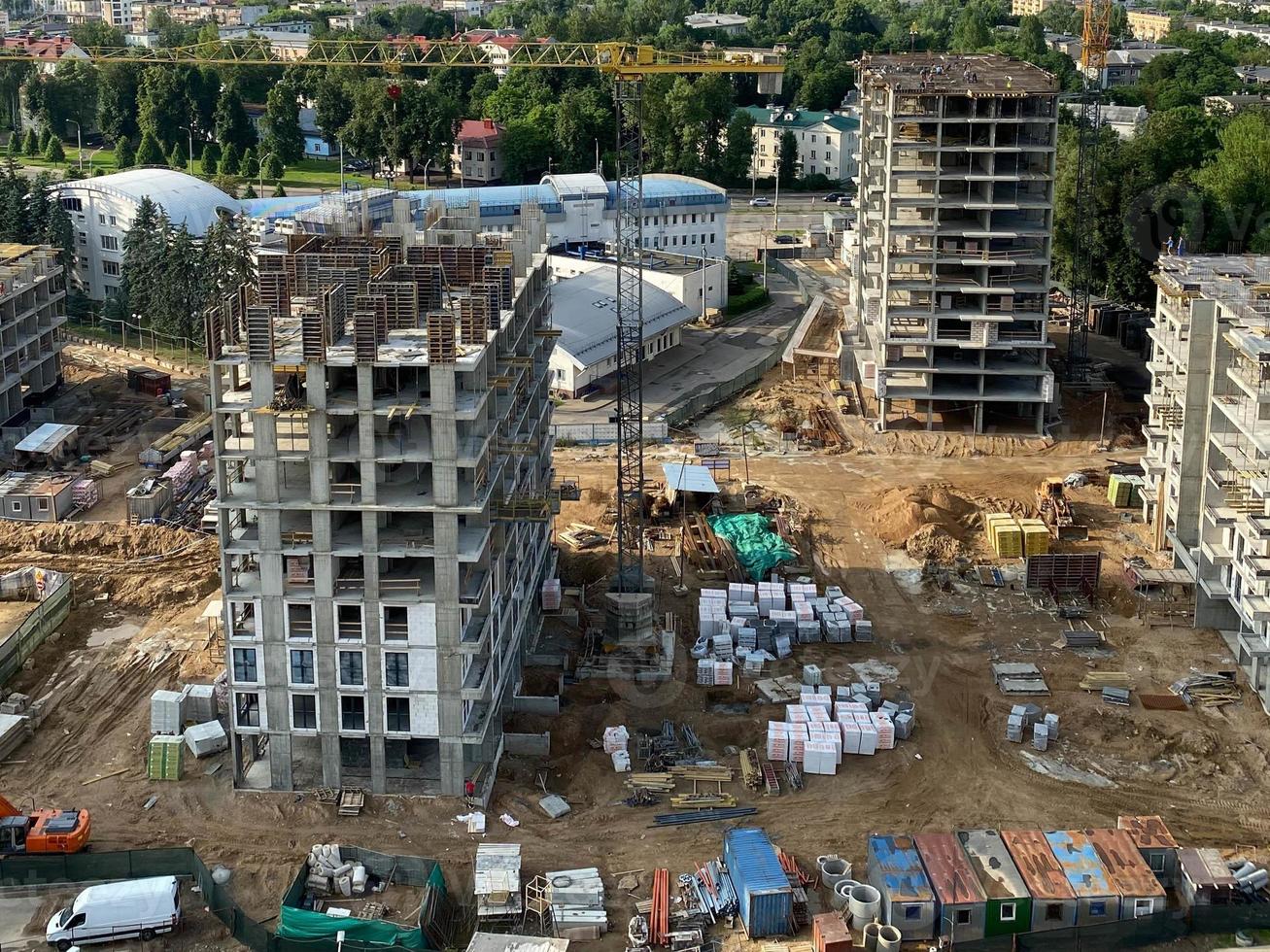 View large-scale construction of a residential complex with a view of construction cranes photo