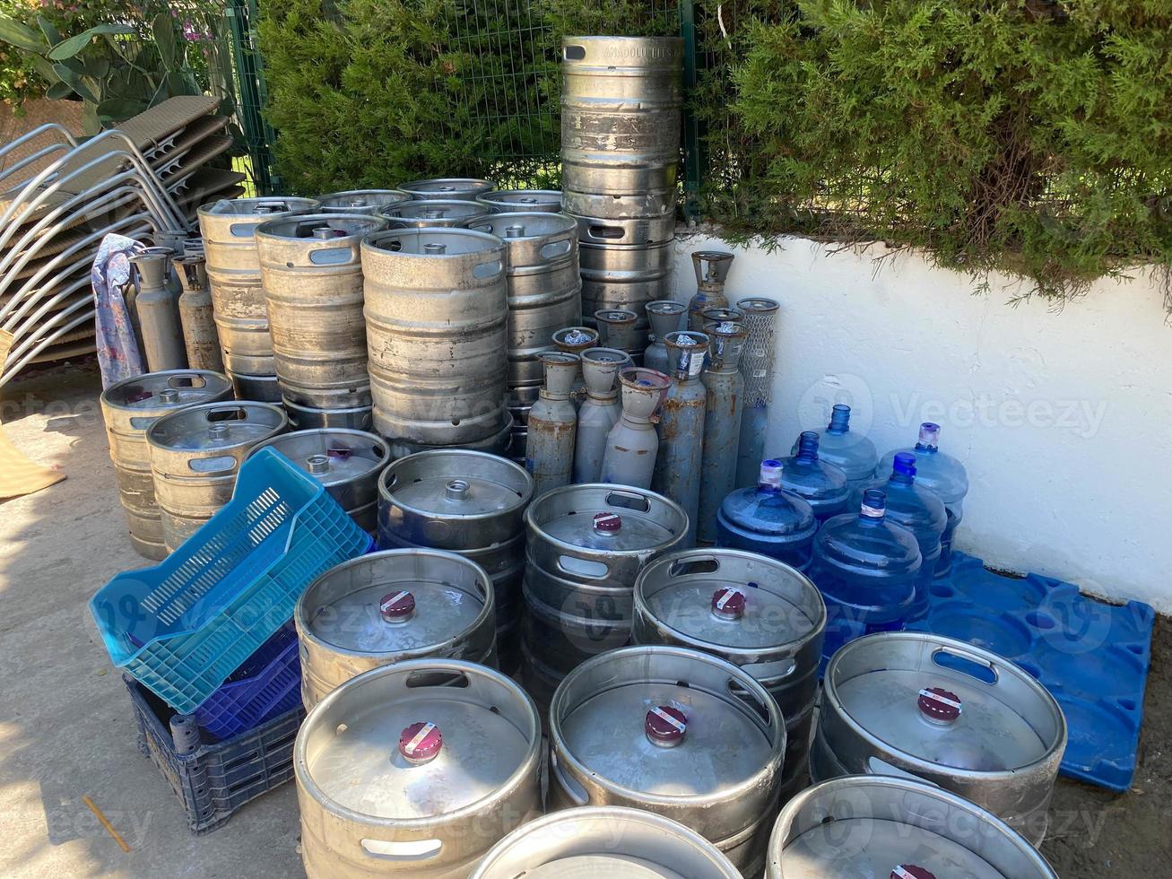 Stock of steel beer kegs on the wooden palettes. Many beer barrels at a beer factory photo