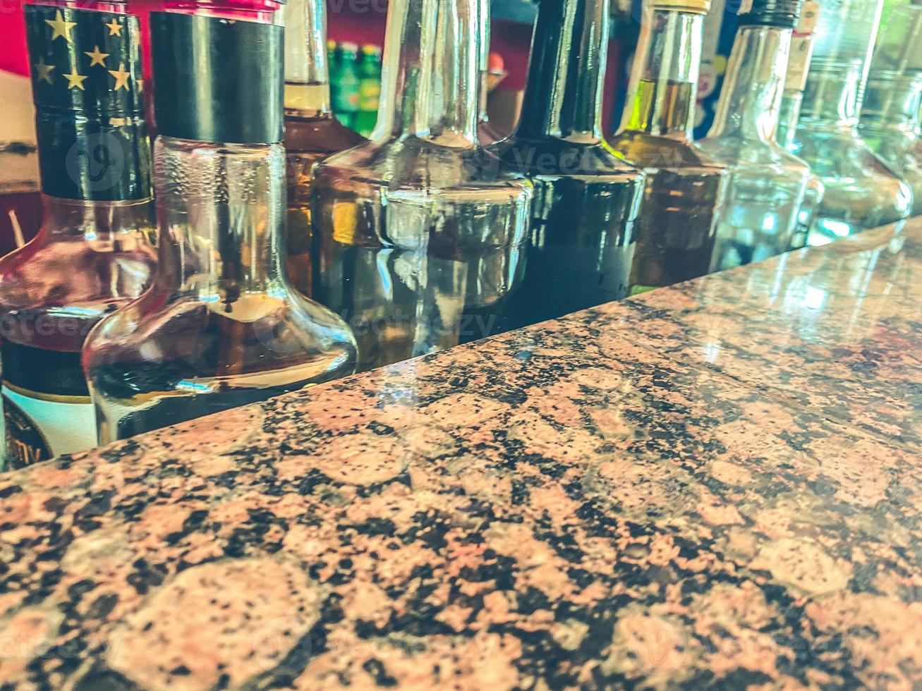 Small liquor production based on maple syrup. Multitude of pure alcohol bottles not labeled. Bottles placed in a row photo