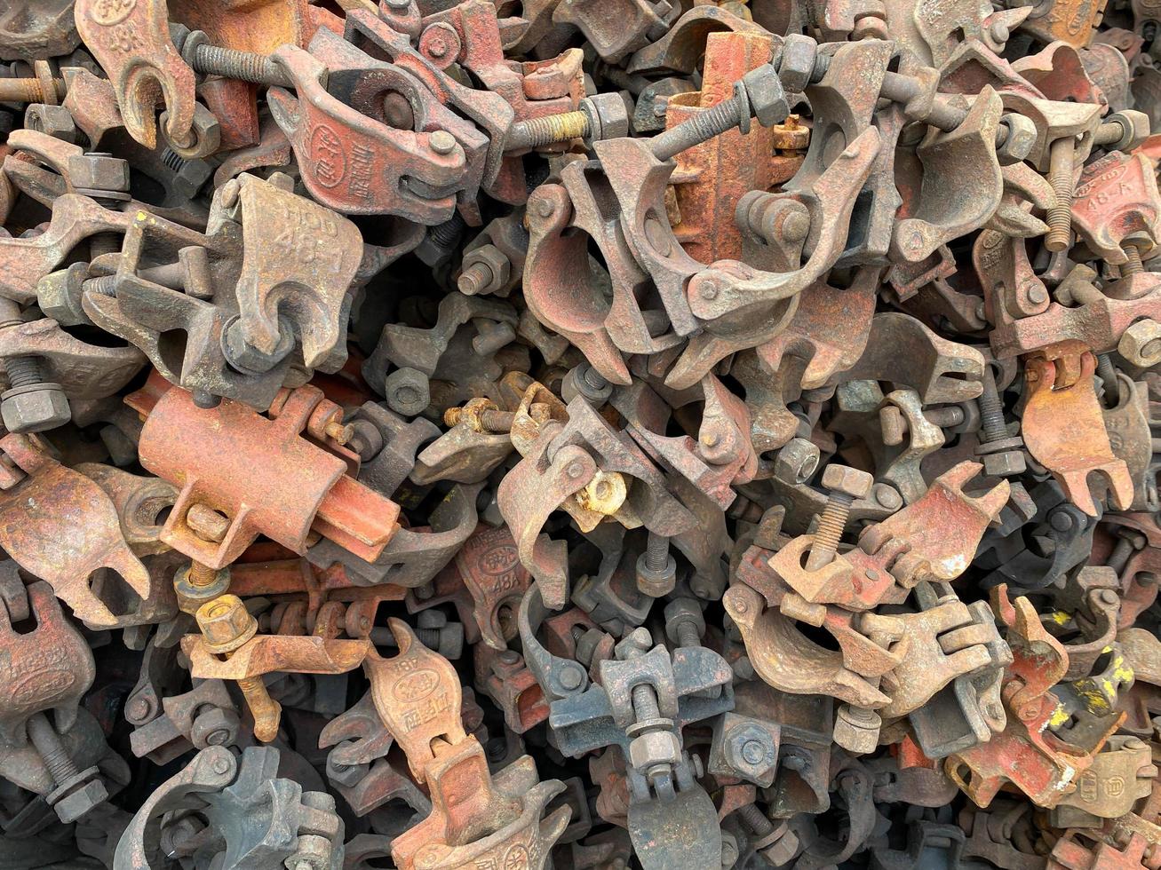 Industrial iron rusty metal clamps clamps hardware fasteners for chemical industry or construction. Background, texture photo