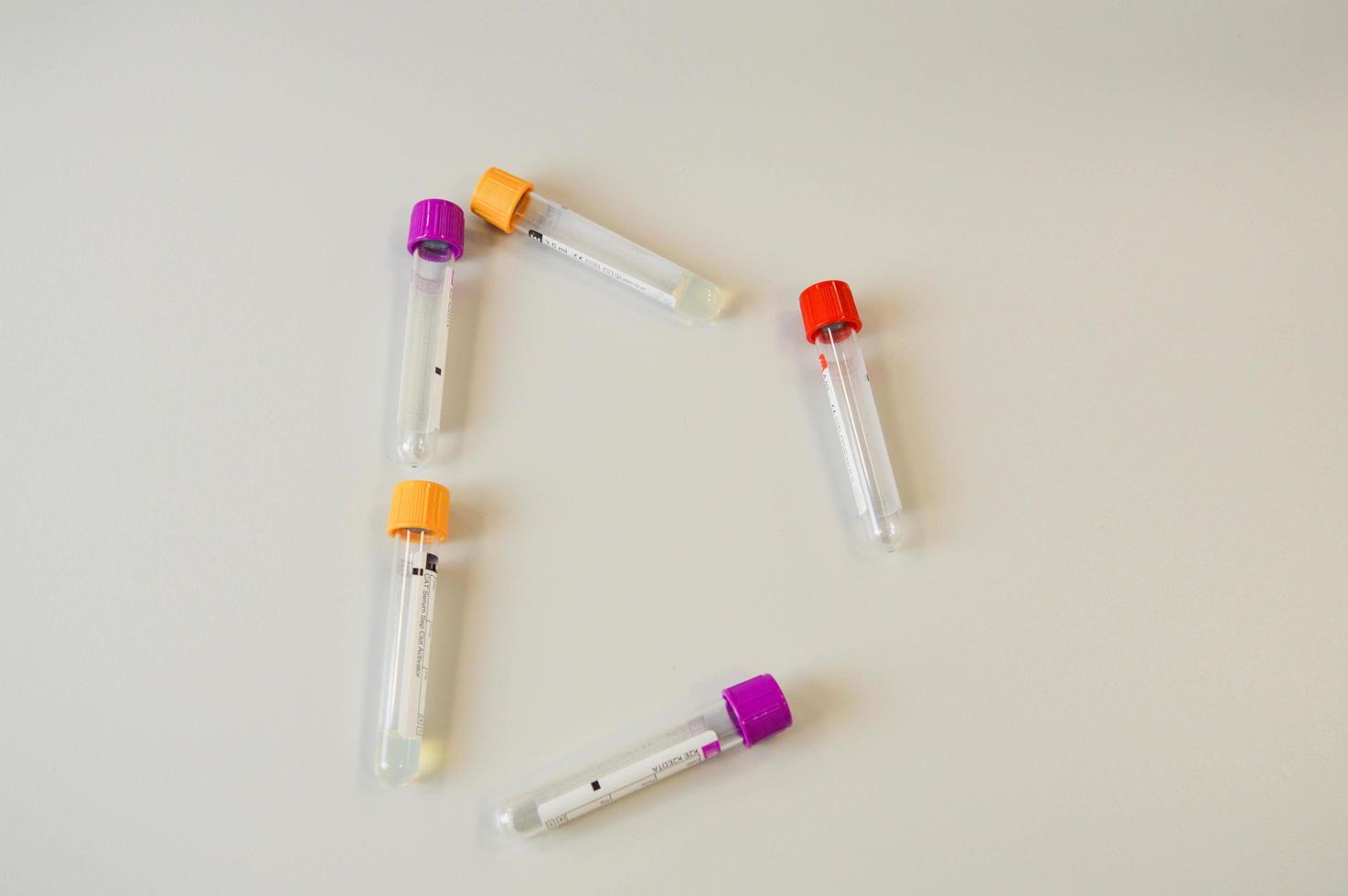 Novel corornavirus test concept. Top above overhead close up view photo of vial with blood sample and label on it isolated over blue color background with copy space