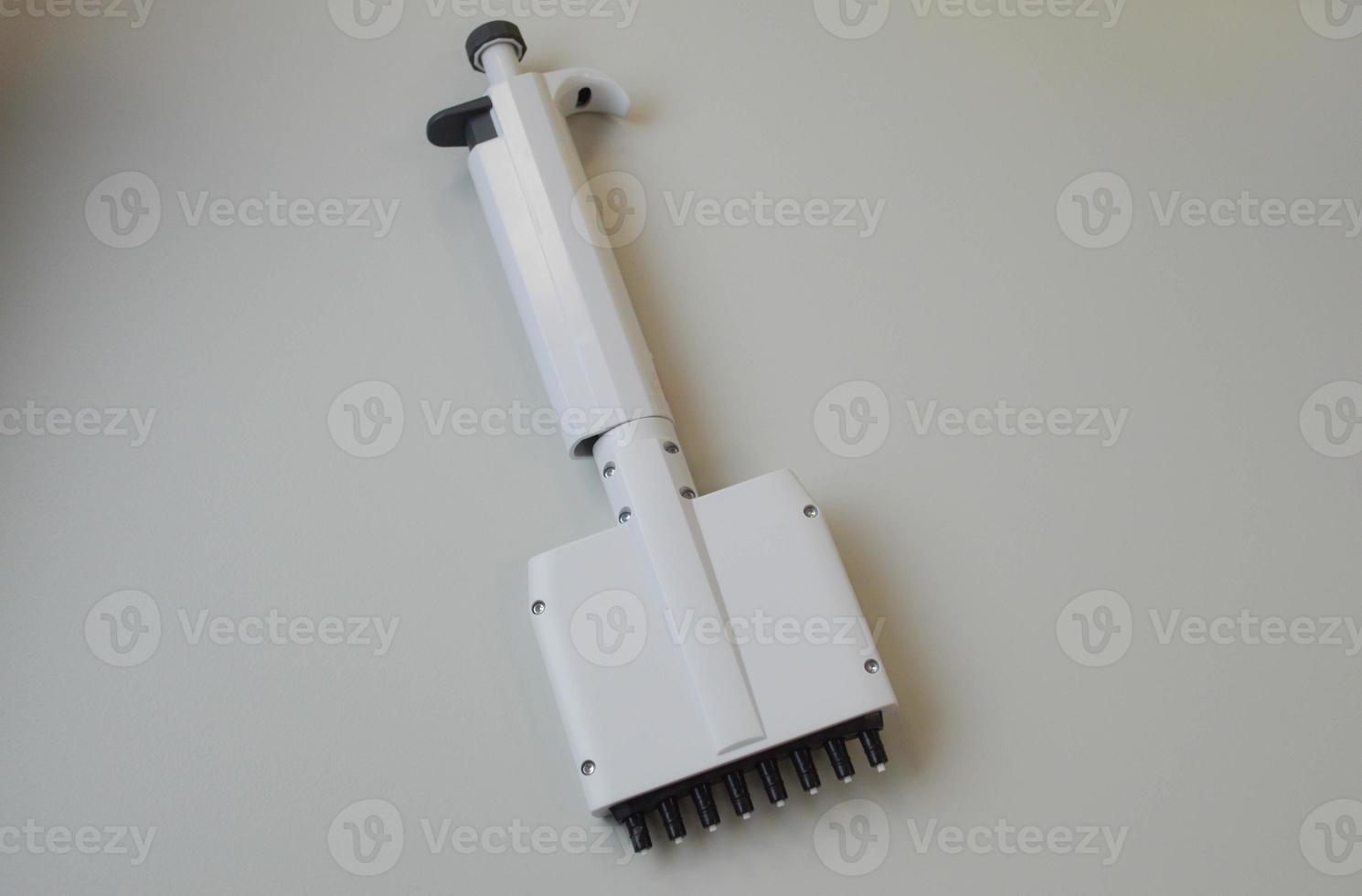 mechanical dispenser for setting test tubes and performing research in laboratory conditions. laboratory diagnostic tool. blood tests from a vein photo