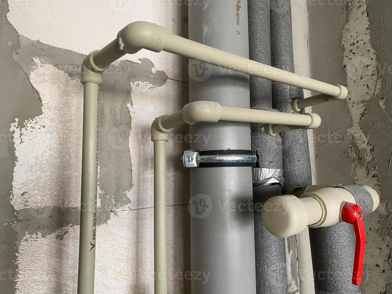 New plastic and polypropylene plastic and polypropylene water and sewer pipes in thermal insulation with shut-off and shut-off and control valves for water consumption in a new house without repair photo