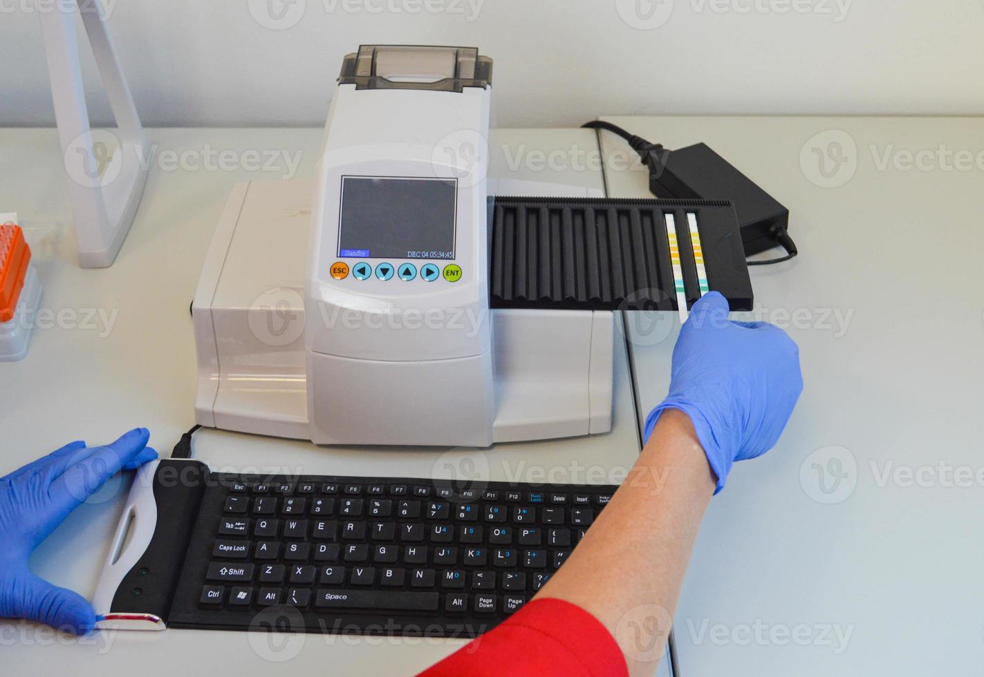 the analyzer automatic for researches of urine. strips for diagnostics of biological material. urinalysis study on laboratory equipment, accurate health diagnostics photo