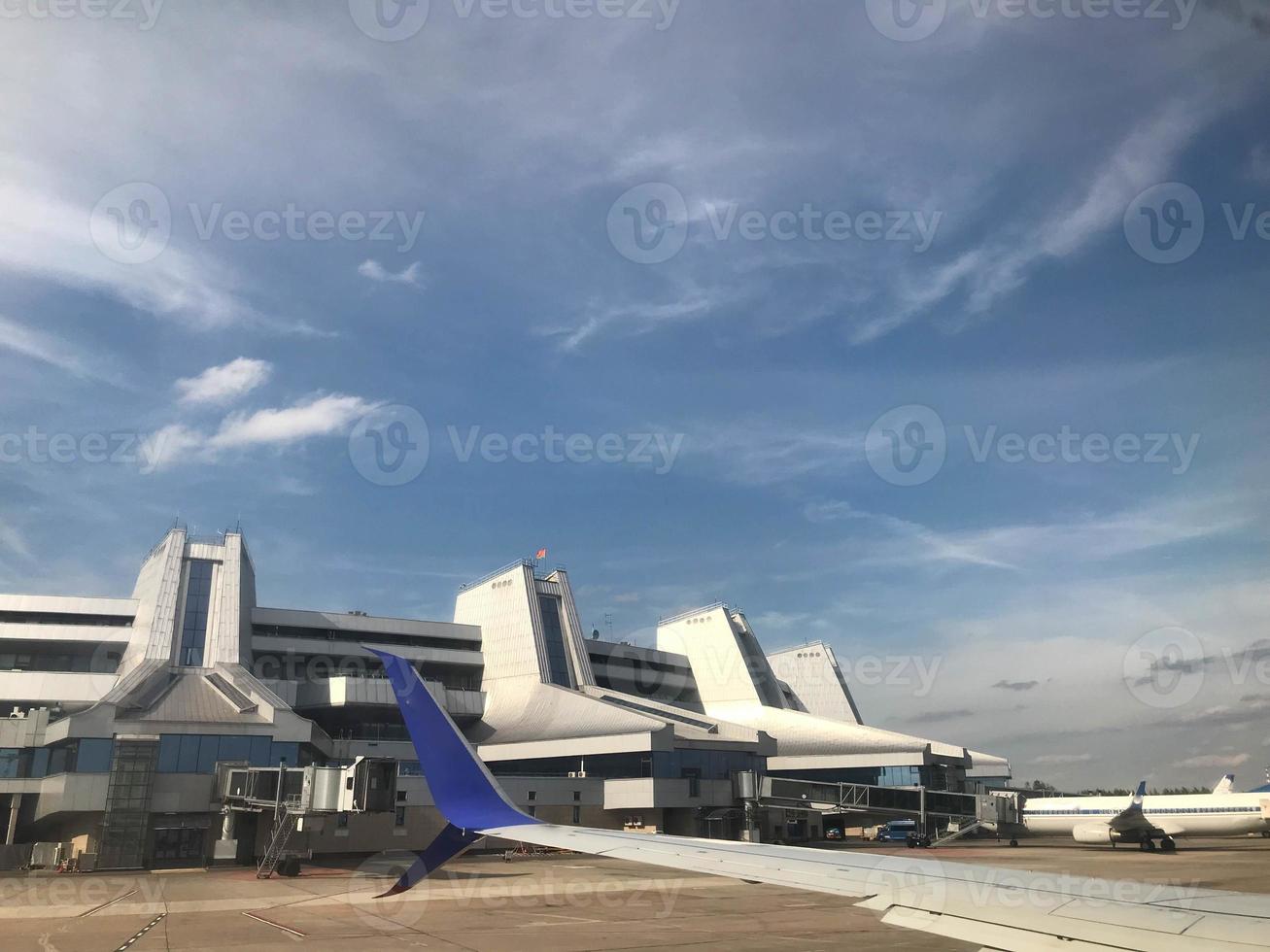 Beautiful view from the window of airplane to blue sky with white clouds at height in sunny day from the passenger seat. Traveling by plane to Europe during the holidays photo