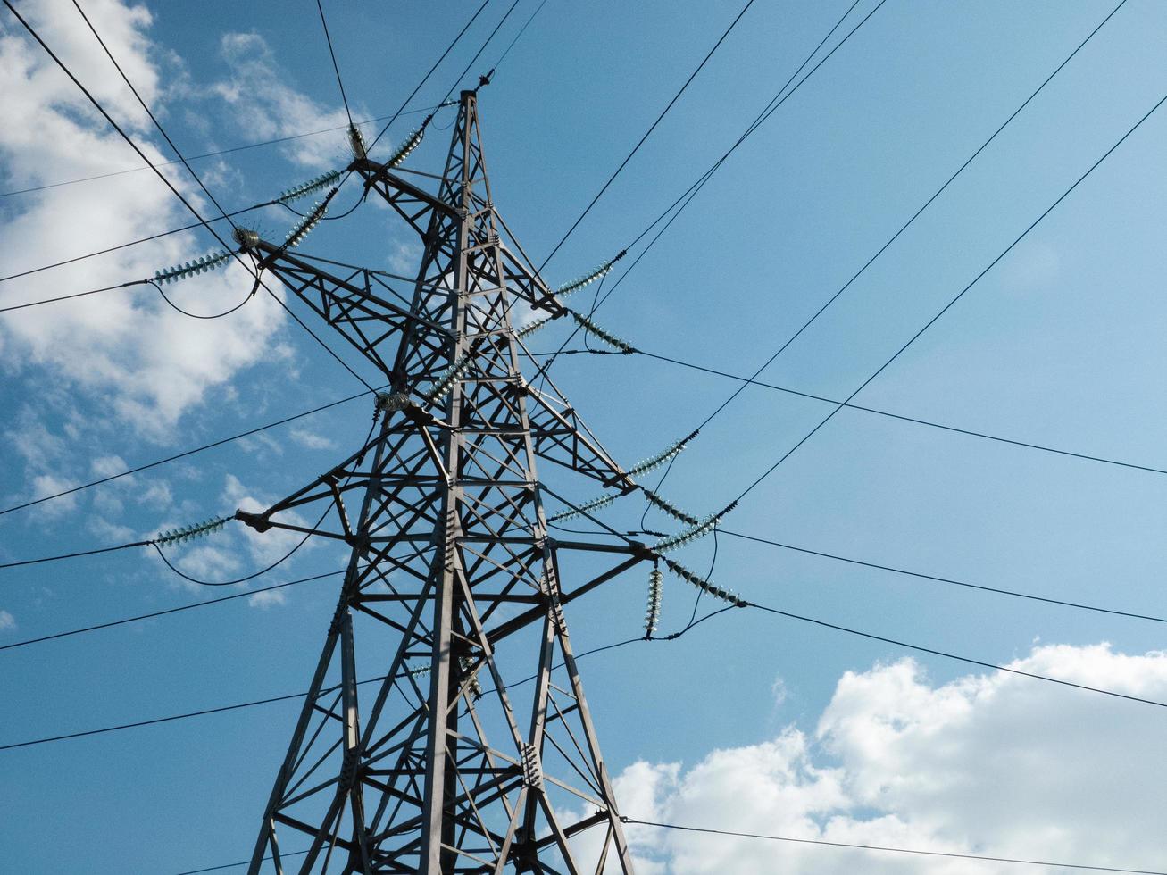 High-voltage corner tower with wires. photo