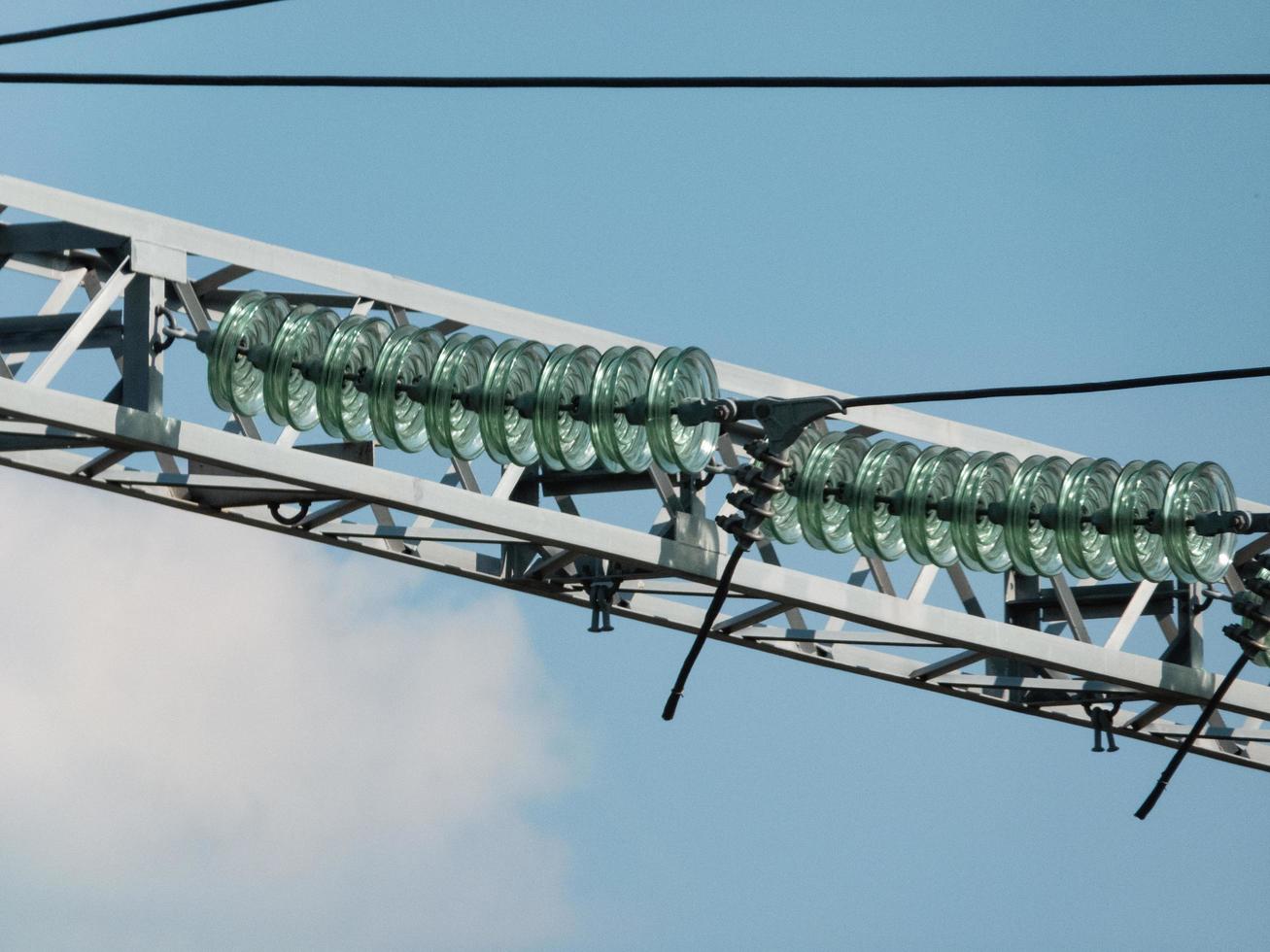 Glass linear isolators on high-voltage wires. photo