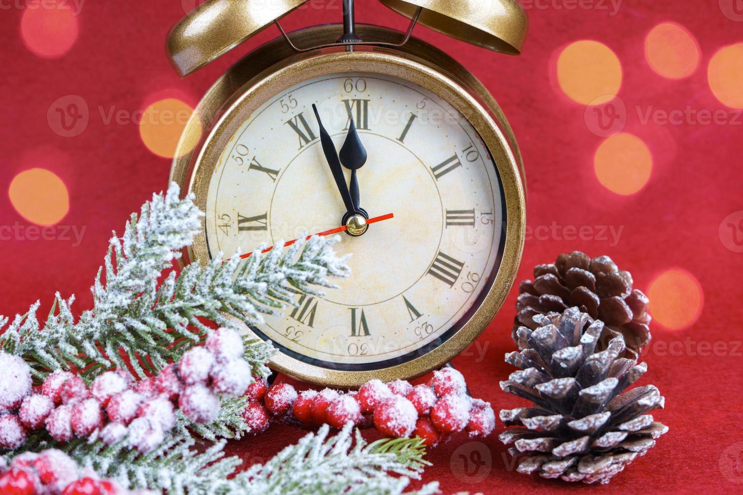 Christmas snow fir tree, alarm clock and gift bag on red background. photo