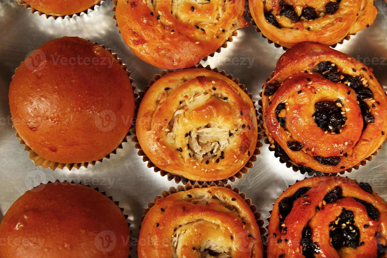 Freshly baked buns with coconut, raisins and sesame seeds. Thai street food. photo