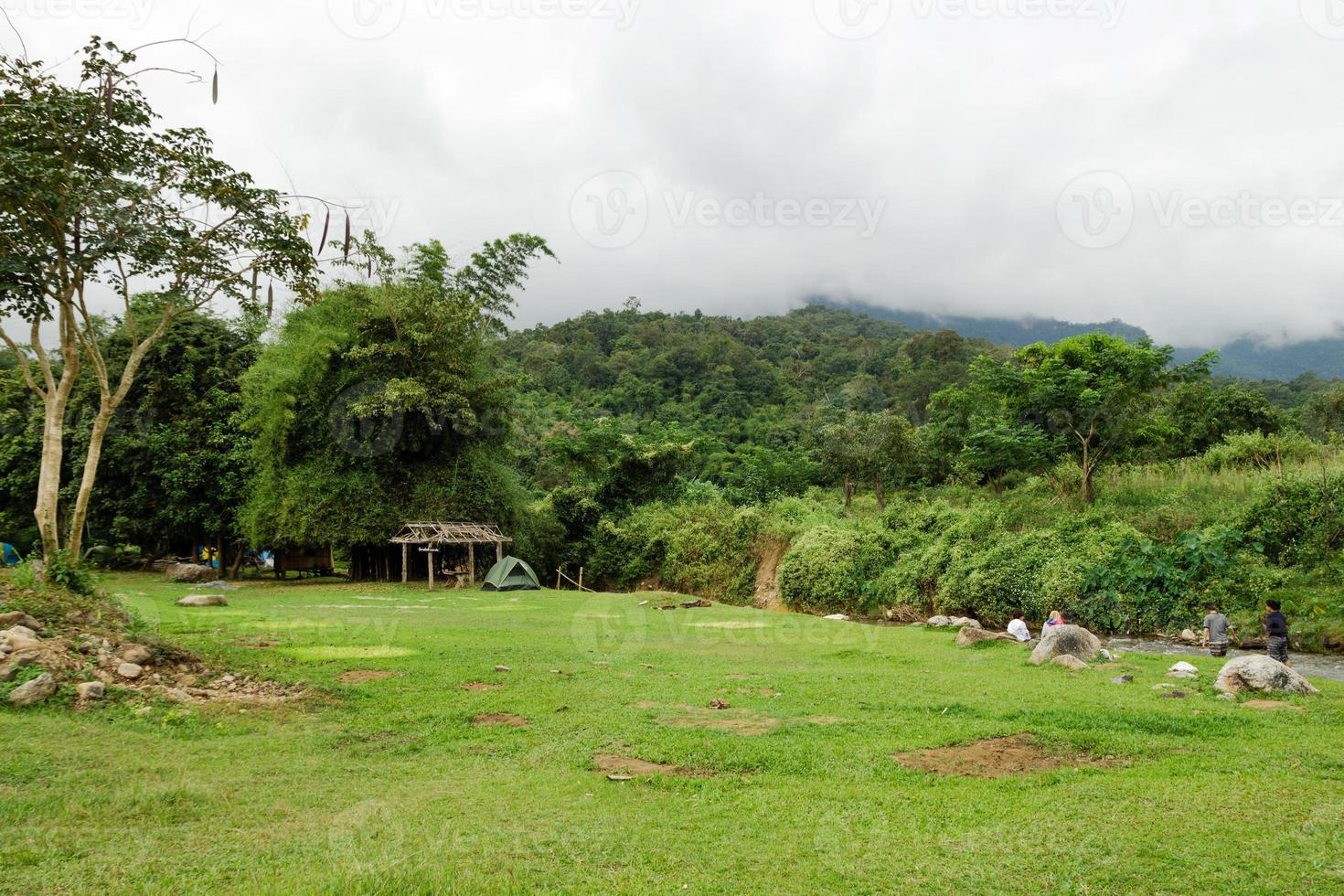 ver en un camping en la selva tropical cerca del río y las montañas en tiempo nublado. chiang dao, tailandia. foto