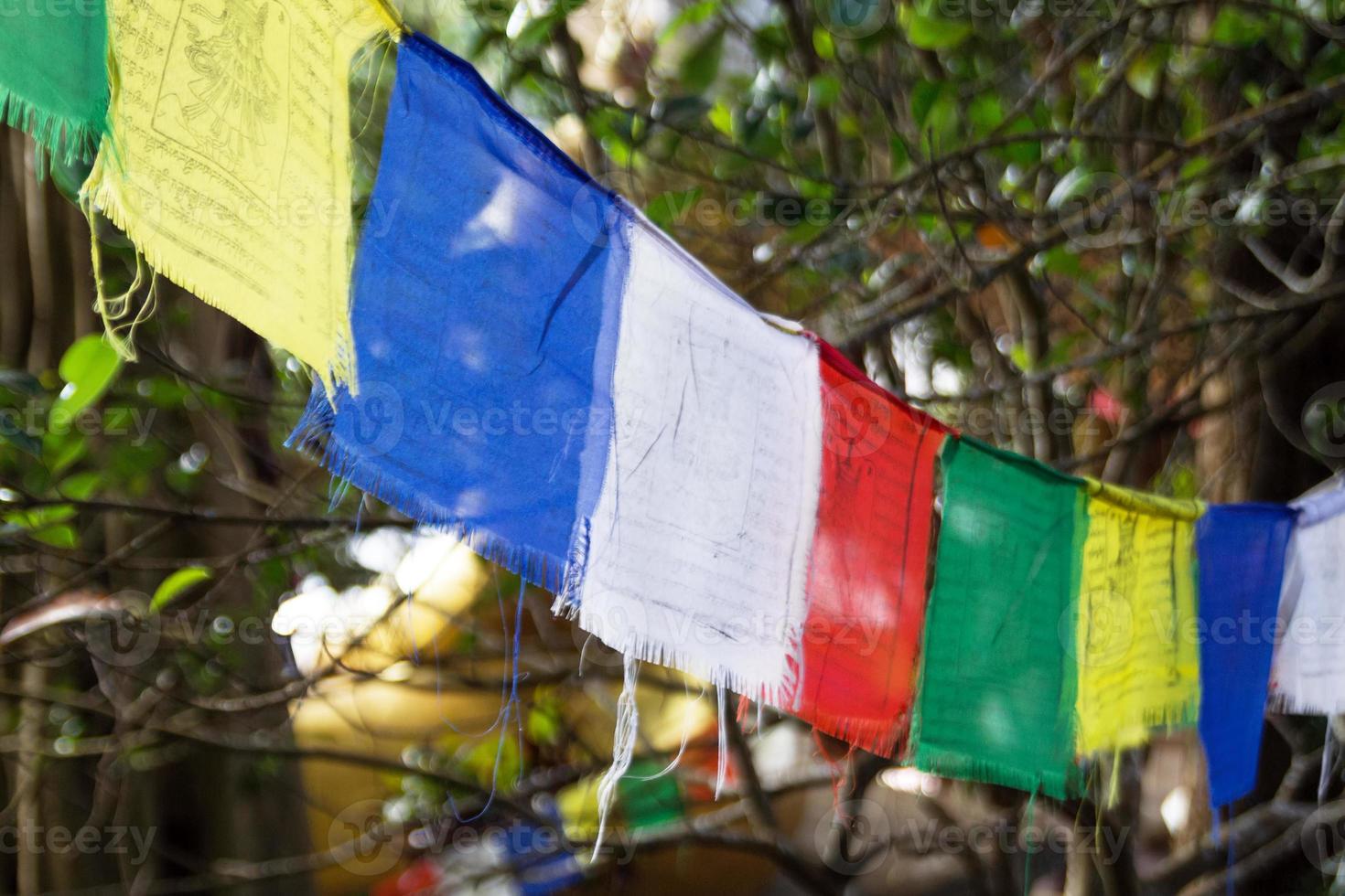 View on a colorful flags on a background of trees on a sunny day. Chiang Mai province, Doi Suthep, Thailand. photo