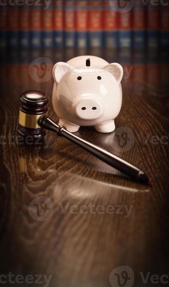 Gavel and Piggy Bank on Wooden Table With Law Books In Background photo