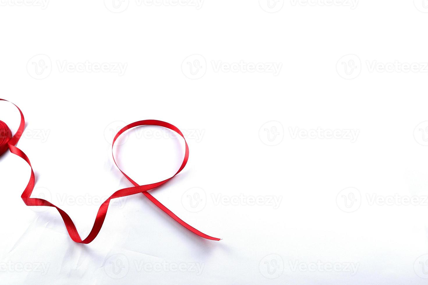 Red Support Ribbon isolated on white background. World aids day and national HIV AIDS and aging awareness month with red ribbon. copyspace area photo