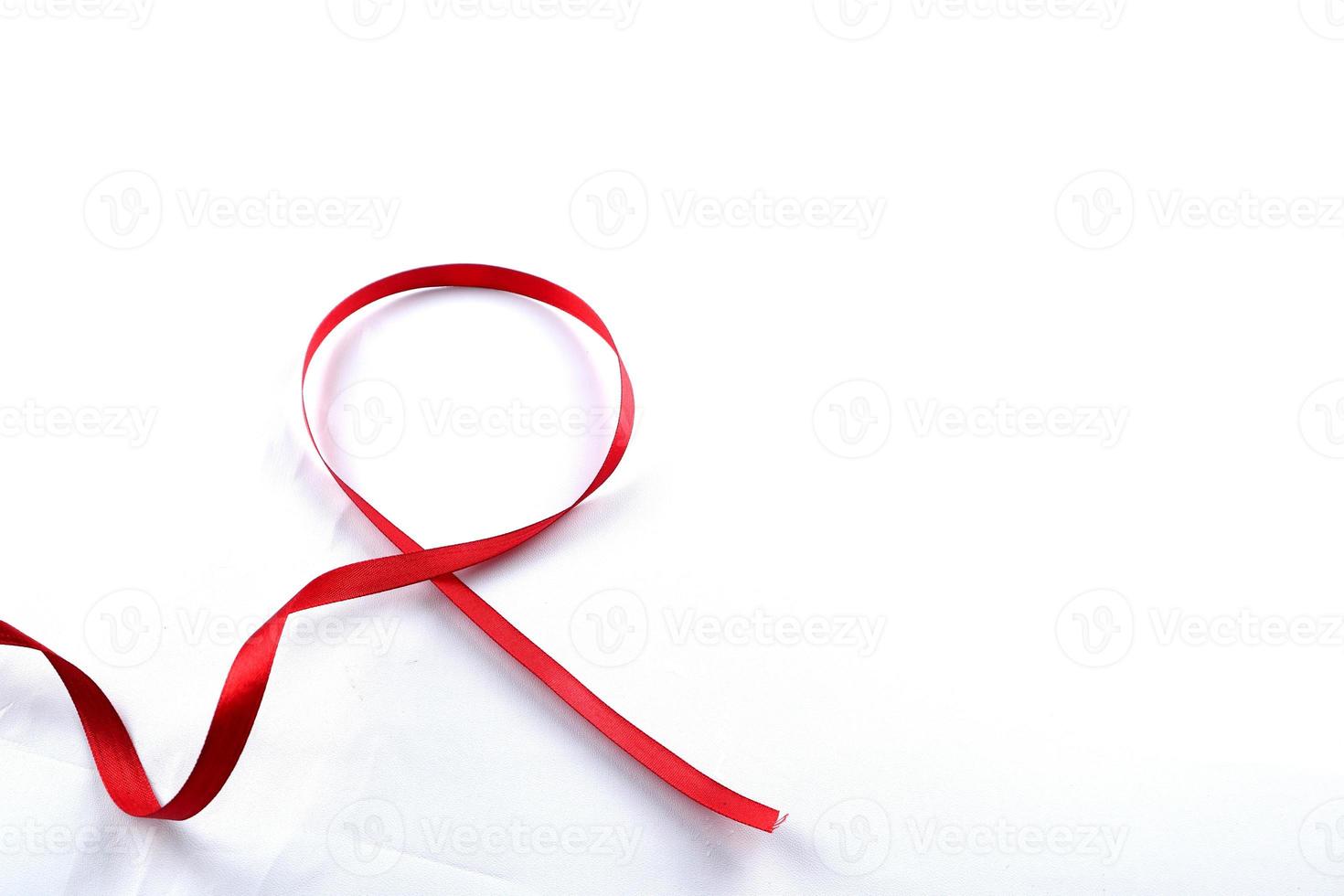 Red Support Ribbon isolated on white background. World aids day and national HIV AIDS and aging awareness month with red ribbon. copyspace area photo