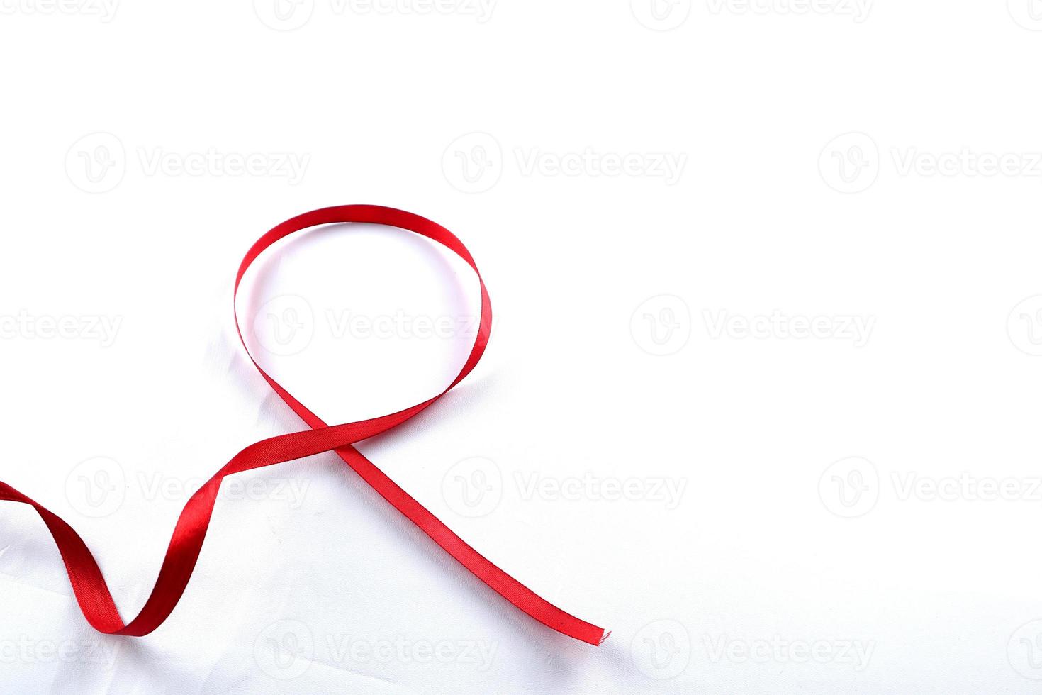 Red Support Ribbon isolated on white background. World aids day and national HIV AIDS and aging awareness month with red ribbon. copyspace area photo