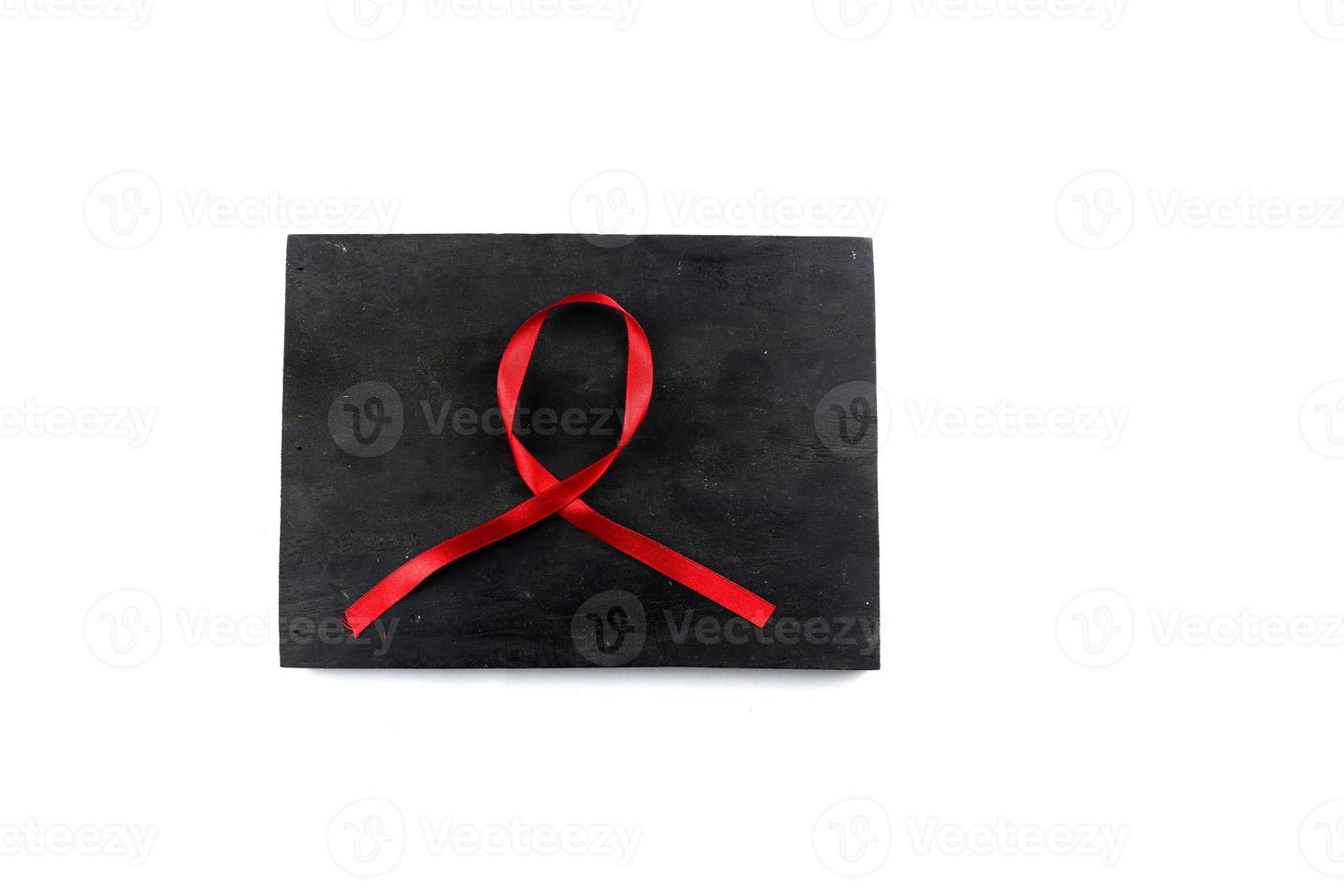 red aids ribbon on old wood background photo