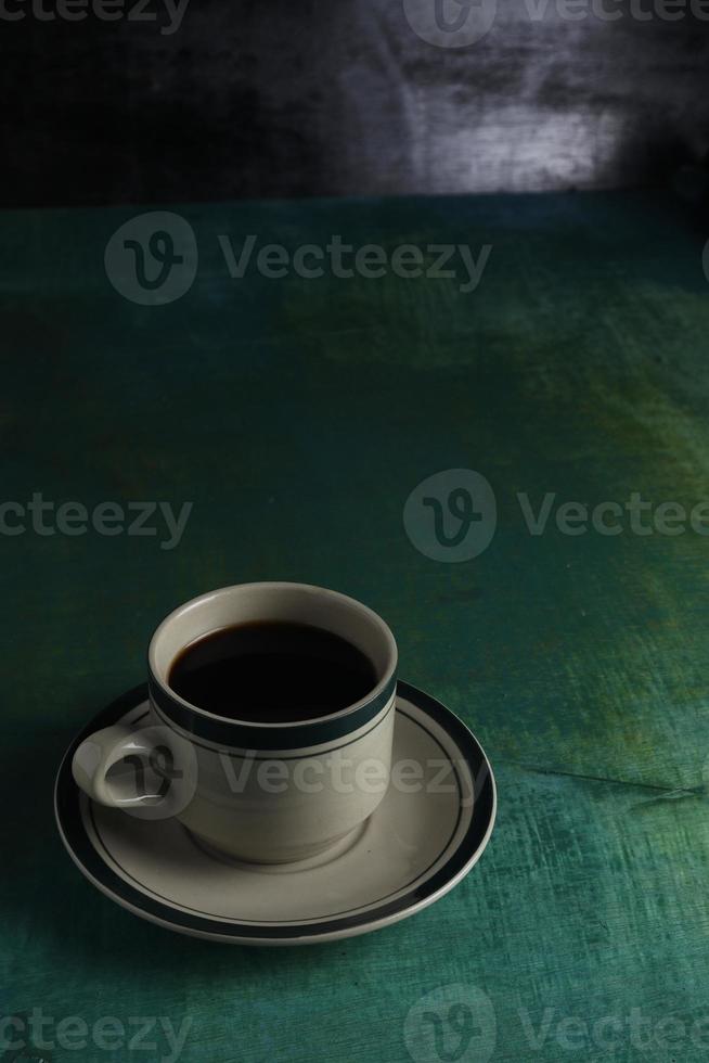 Cup of coffee on green background photo