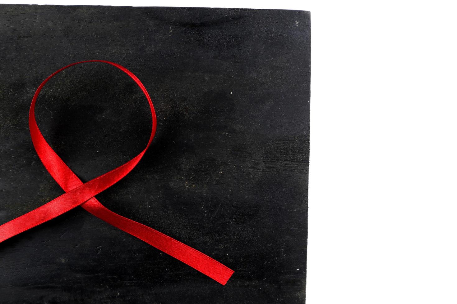 red aids ribbon on old wood background photo