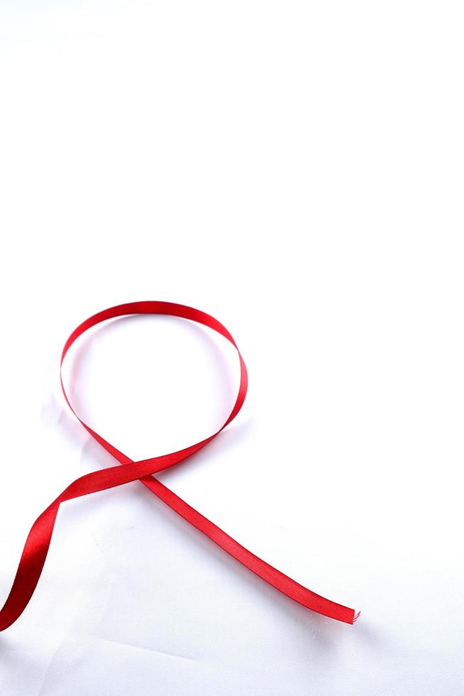 Red Support Ribbon isolated on white background. World aids day and national HIV AIDS and aging awareness month with red ribbon. copyspace area photo