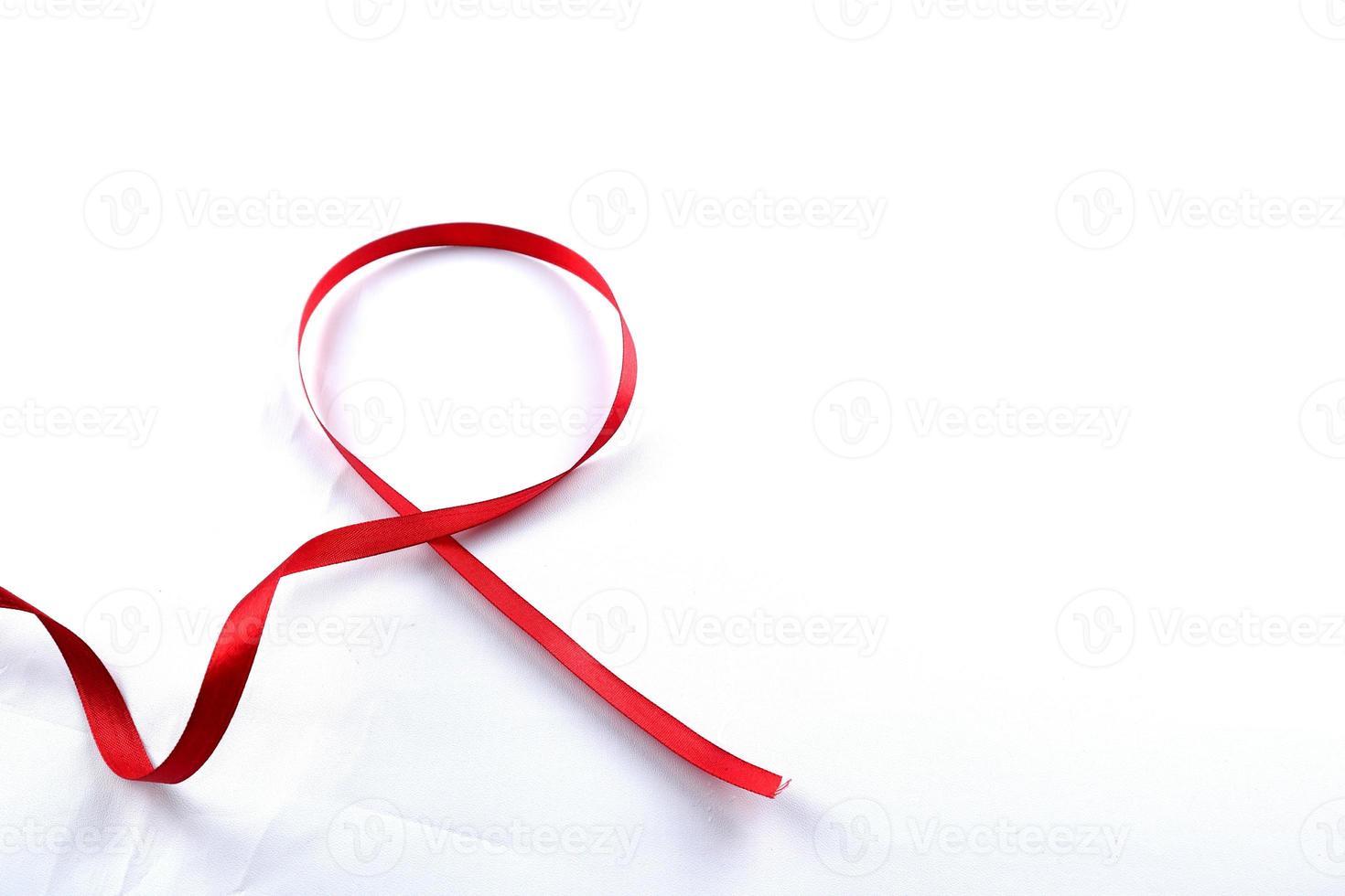 Red Support Ribbon isolated on white background. World aids day and national HIV AIDS and aging awareness month with red ribbon. copyspace area photo