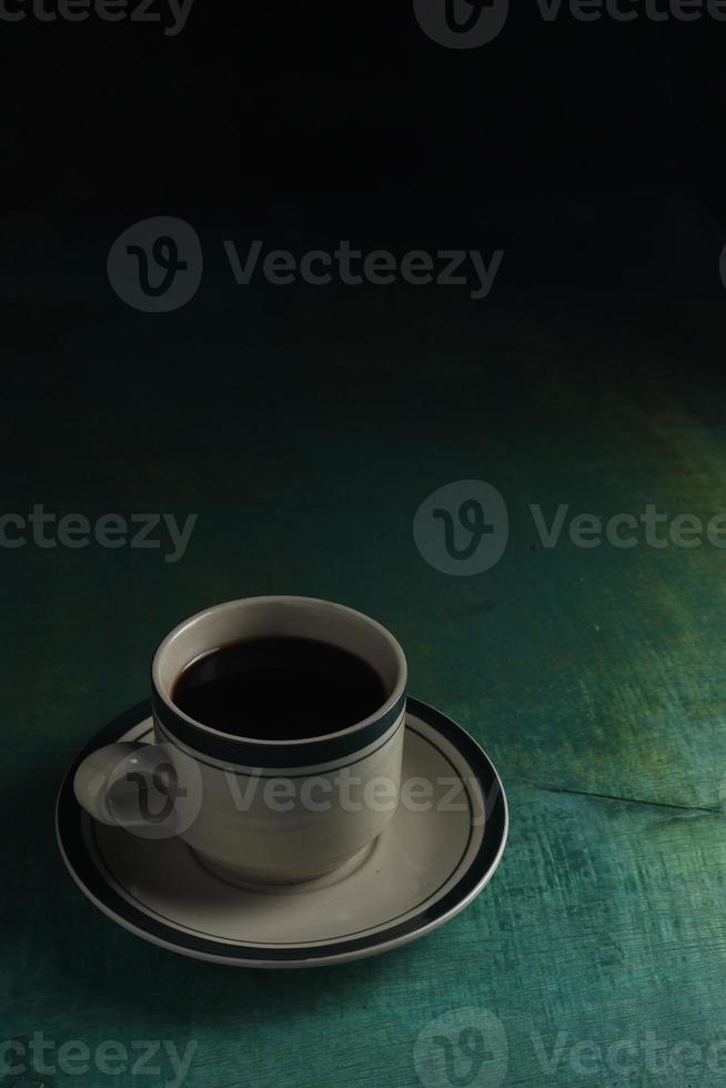 Cup of coffee on green background photo