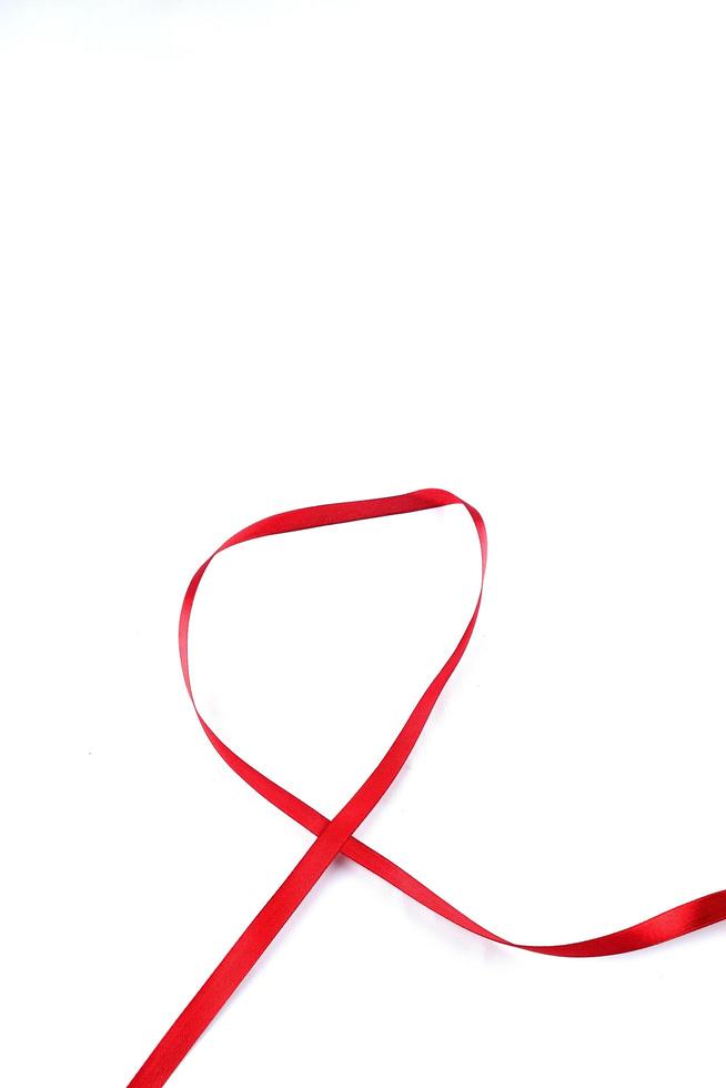 Red Support Ribbon isolated on white background. World aids day and national HIV AIDS and aging awareness month with red ribbon. copyspace area photo