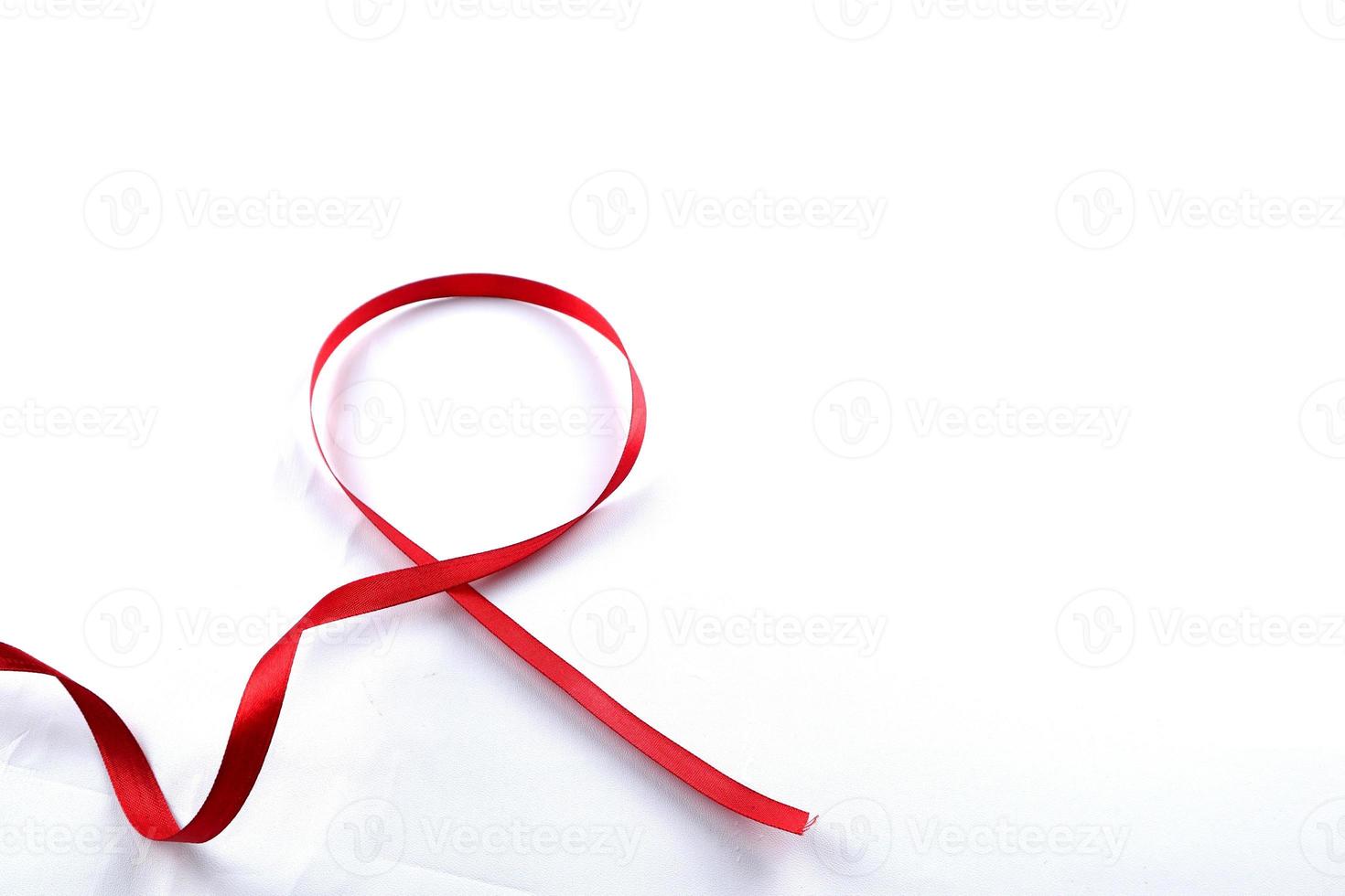 Red Support Ribbon isolated on white background. World aids day and national HIV AIDS and aging awareness month with red ribbon. copyspace area photo