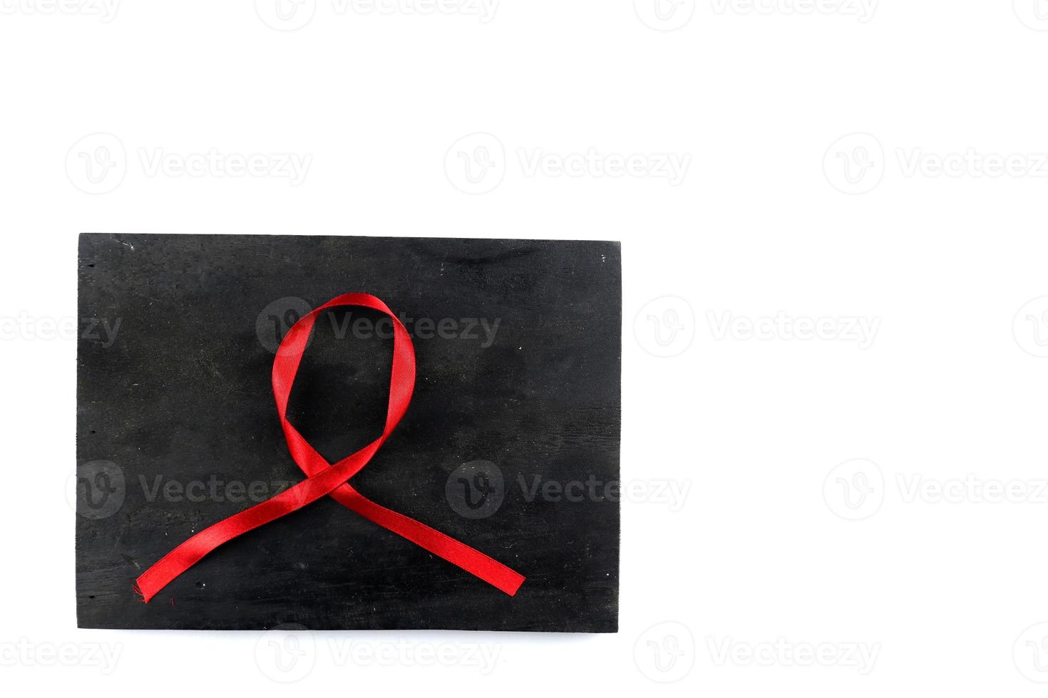 red aids ribbon on old wood background photo